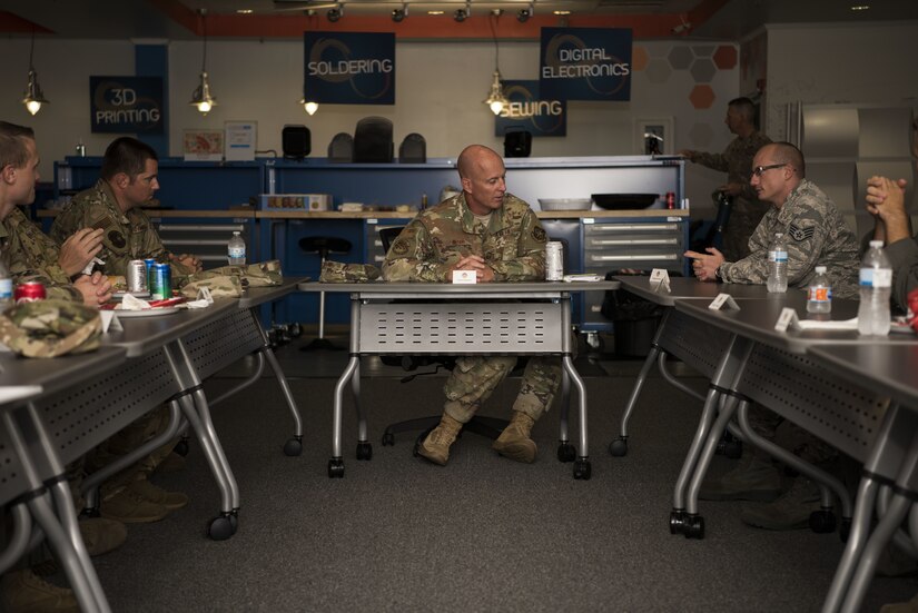 U.S. Air Force Chief Master Sgt. Chris Simpson, 18th Air Force command chief receives input from NCOs during a tour on Joint Base McGuire-Dix-Lakehurst, N.J., Aug. 2, 2019. Simpson sat down with Airmen to discuss how their units are operating and the mental state of their co-workers. (U.S. Air Force photo by Airman 1st Class Ariel Owings)