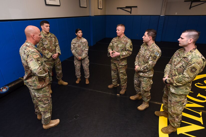 U.S. Air Force Chief Master Sgt. Chris Simpson, 18th Air Force command chief listens to the Expeditionary Operations School Phoenix Raven qualification instructors during a tour on Joint Base McGuire-Dix-Lakehurst, N.J., Aug. 2, 2019. The instructors described the types of training conducted and the importance it has on missions in austere environments. (U.S. Air Force photo by Airman 1st Class Ariel Owings)