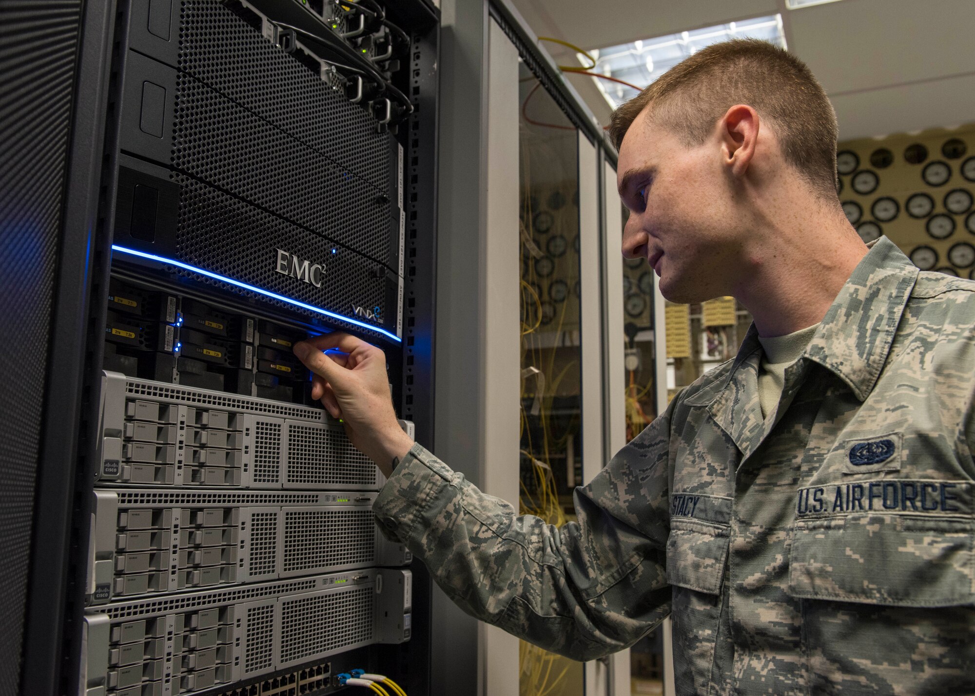 U.S. Air Force Senior Airman Dorian Stacy, 423rd Communications Squadron network operations technician, inspects the backup hard drives at RAF Alconbury, England, August 8, 2019. Stacy is in charge of securing network operations and ensuring proper access and permissions are in place at RAF Alconbury and RAF Molesworth. (U.S. Air Force photo by Airman 1st Class Jennifer Zima)