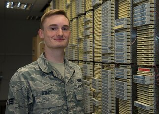 U.S. Air Force Senior Airman Dorian Stacy, 423rd Communications Squadron network operations technician, poses for a photo in a network server room at RAF Alconbury, England, August 8, 2019. Stacy is in charge of securing network operations and ensuring proper access and permissions are in place at RAF Alconbury and RAF Molesworth. (U.S. Air Force photo by Airman 1st Class Jennifer Zima)