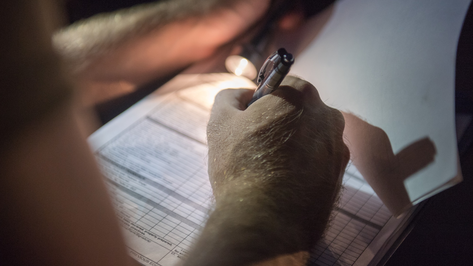 U.S. Air Force Staff Sgt. Steven Gentry, 386th Expeditionary Logistics Readiness Squadron special handling lead joint inspector, takes notes while inspecting a U.S. Army UH-60 Black Hawk helicopter at Ali al Salem Air Base, Kuwait, Aug. 9, 2019. A team of Airmen and Soldiers inspect the Black Hawks to ensure they're airworthy to load onto U.S. Air Force C-17 Globemaster III aircraft where they'll undergo transport to a location within the U.S. Central Command area of responsibility. (U.S. Air Force photo by Tech. Sgt. Daniel Martinez)