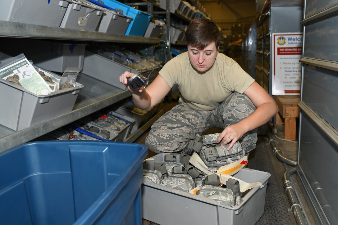 an Airmen organizes items in supply