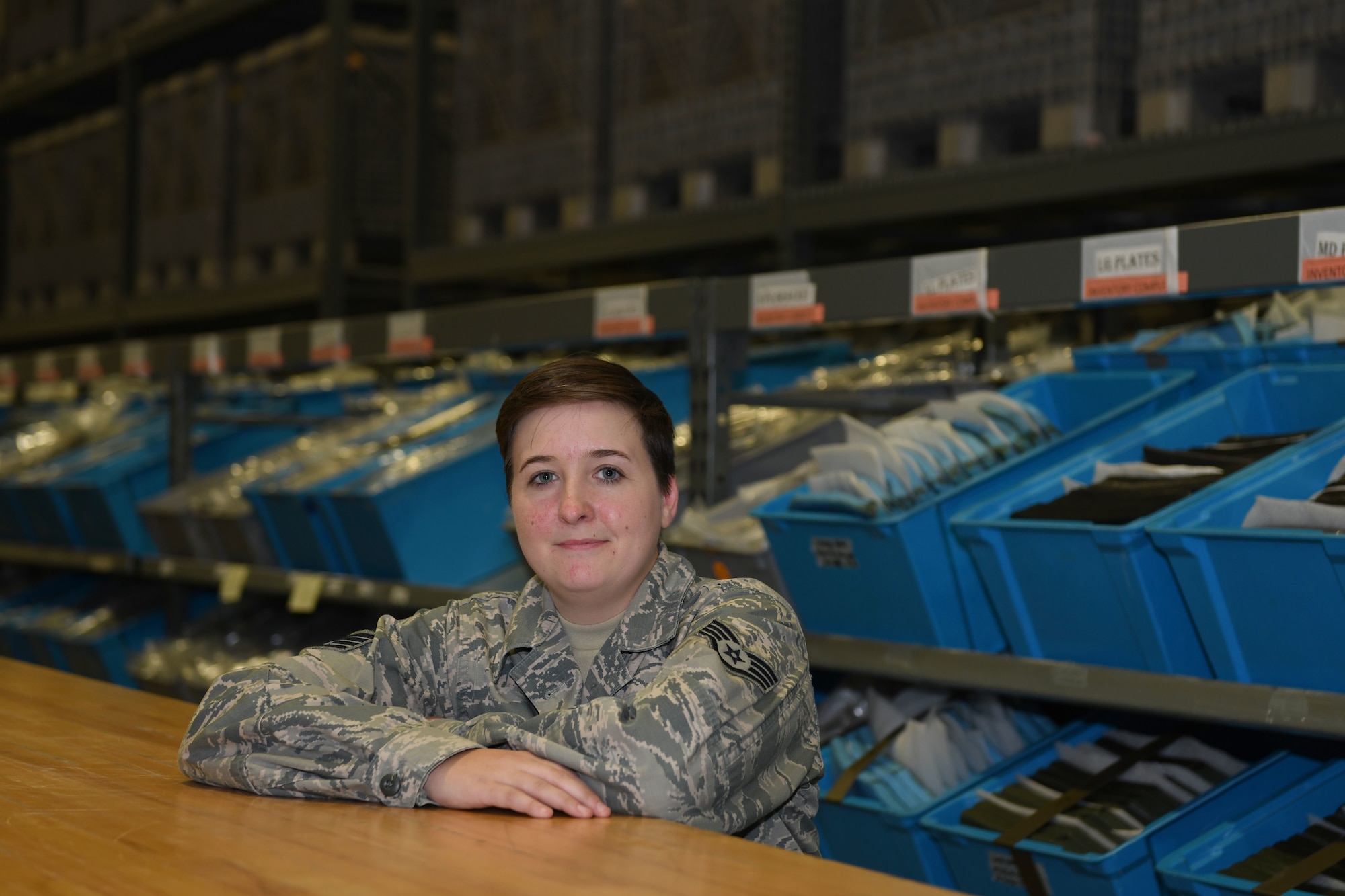 an Airmen poses for a photo in supply