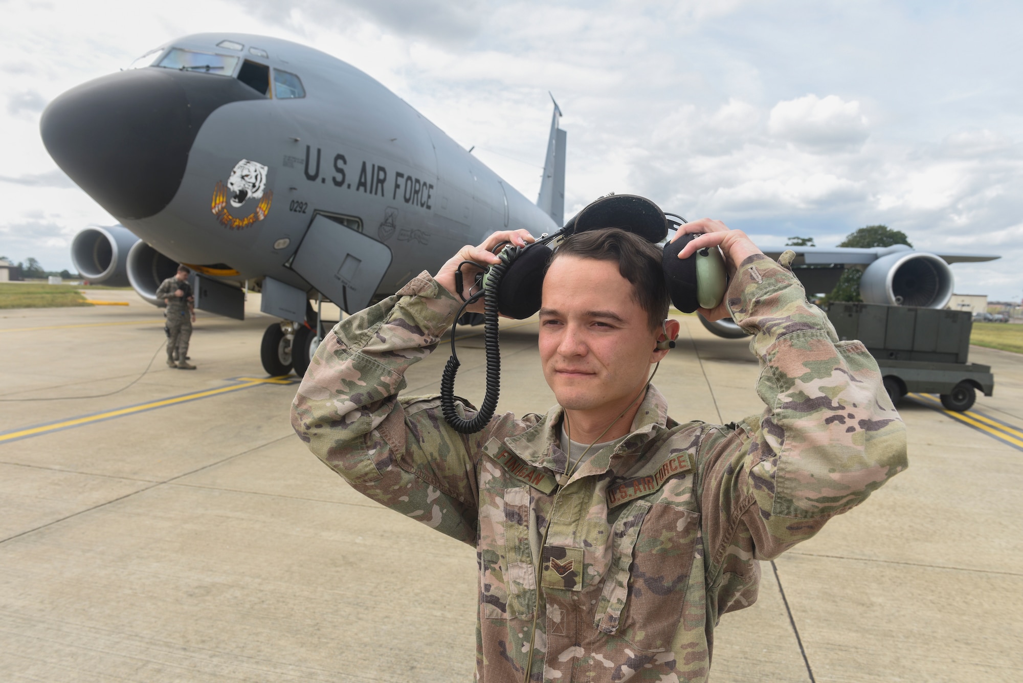U.S. Air Force Senior Airman Joseph Finigan, 100th Aircraft Maintenance Squadron aircraft hydraulics systems journeyman, puts on a second layer of hearing protection over his dual in-ear headset at RAF Mildenhall, England, Aug. 6, 2019. The headset enables communication by transmitting sound waves through the bones in the user’s ear.  (U.S. Air Force photo by Airman 1st Class Joseph Barron)