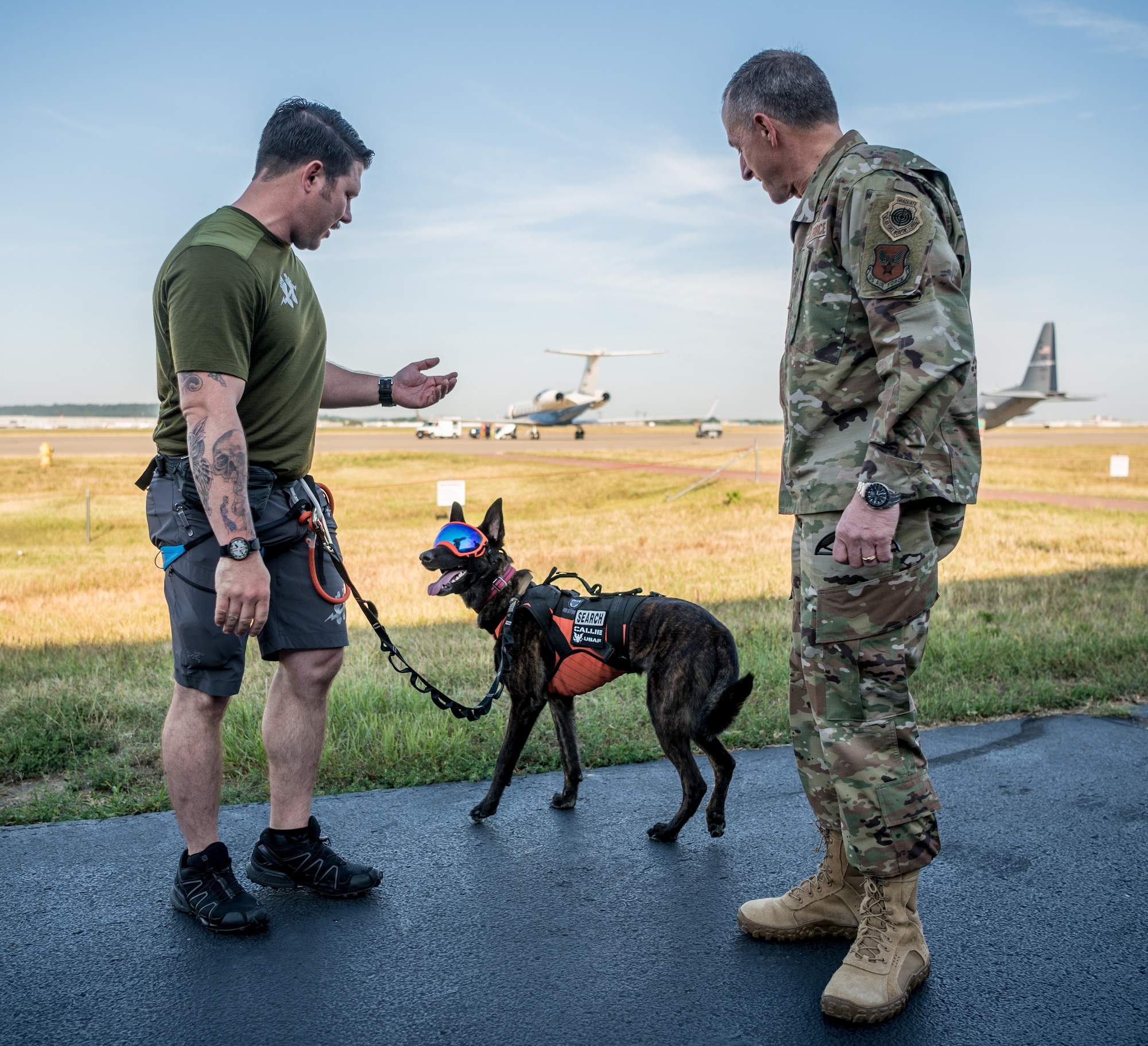 Air Force Chief of Staff Gen. David L. Goldfein (right), meets Callie, the only search-and-rescue dog in the Department of Defense, and her handler, Master Sgt. Rudy Parsons, a pararescueman in the 123rd Special Tactics Squadron, during a tour of the Kentucky Air National Guard Base in Louisville, Ky., Aug. 10, 2019. Goldfein toured various work centers, learning about the unique mission sets of the 123rd Airlift Wing. (U.S. Air National Guard photo by Staff Sgt. Joshua Horton)