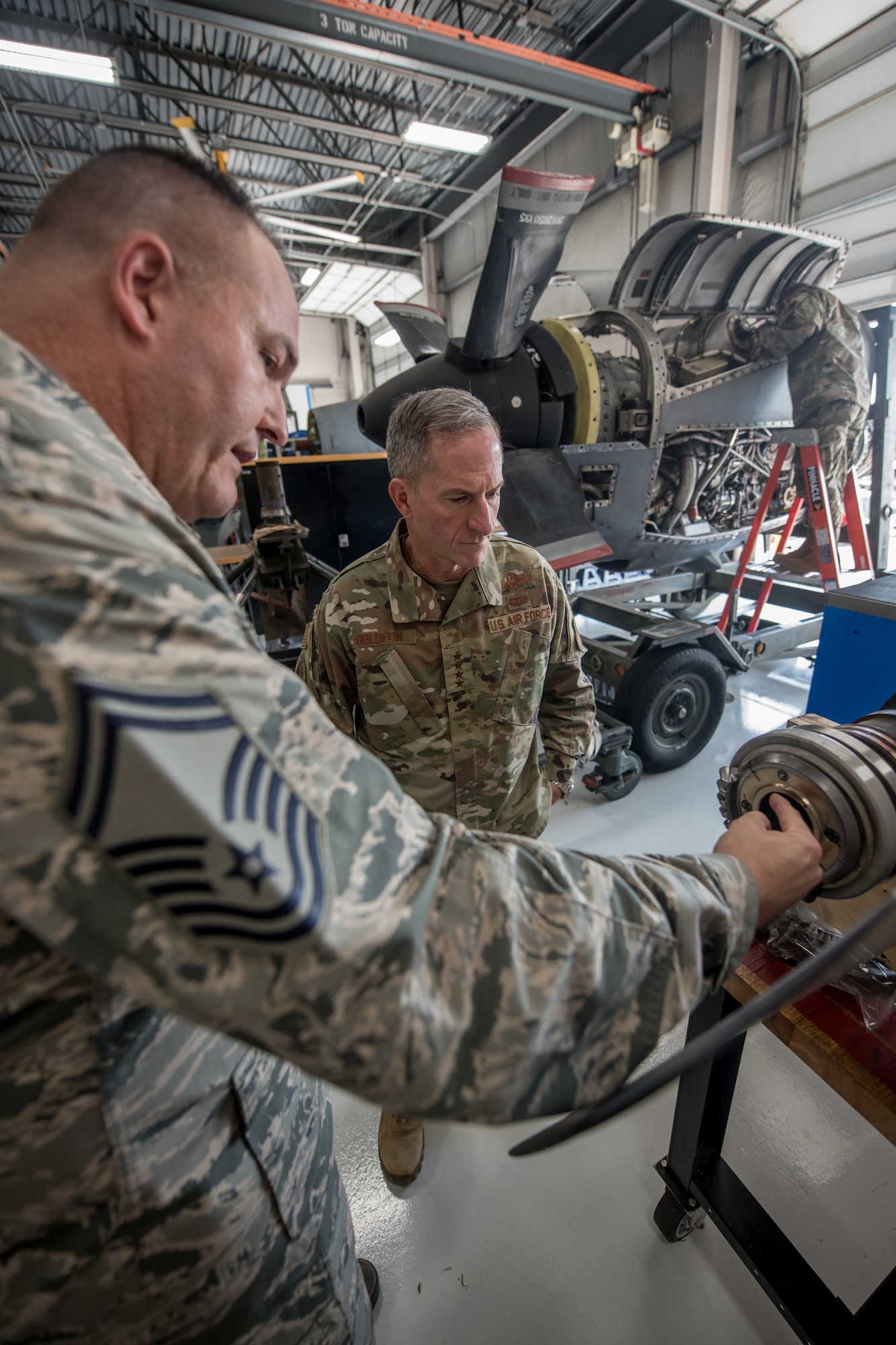Senior Master Sgt. John Wardrip (left), propulsion element supervisor for the 123rd Maintenance Group, speaks with Air Force Chief of Staff Gen. David L. Goldfein during a tour of the Kentucky Air National Guard Base in Louisville, Ky., Aug. 10, 2019. Goldfein visited various work centers, learning about the unique mission sets of the 123rd Airlift Wing. (U.S. Air National Guard photo by Staff Sgt. Joshua Horton)