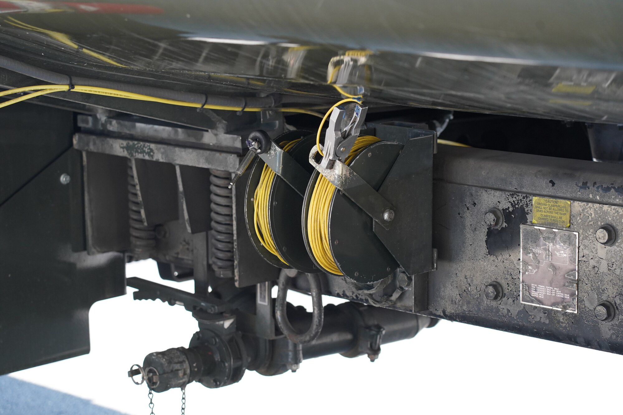 Grounding cables are seen on the side of a fuel truck before Airmen assigned to the 673d Logistics Readiness Squadron refuel an F-22 Raptor of the 525th Fighter Squadron (the Bulldogs) on Joint Base Elmendorf-Richardson, Alaska, Aug. 9, 2019.  Fuels specialists manage every aspect of the refueling every aircraft on the flight line and are responsible for operating the vehicles, equipment and storage facilities that are essential to refueling operations while ensuring compliance with all safety regulations while handling these volatile liquids.