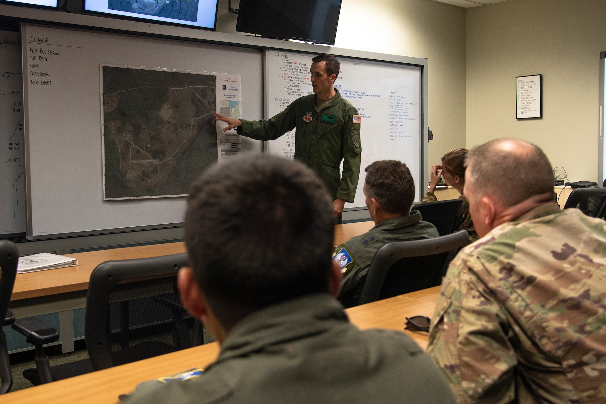 U.S. Air Force Capt. Christopher Allen, 41st Rescue Squadron (RQS) flight commander, briefs Ninth Air Force leadership before a flight at Moody Air Force Base, Ga., Aug. 8, 2019. U.S. Air Force Maj. Gen. Chad Franks, Ninth Air Force commander, flew the initial flight in his flagship aircraft, an HH-60G Pave Hawk assigned to the 41st RQS. Franks, who on separate occasions served as the commander for the 23d Wing and 347th Rescue Group, is a command pilot with more than 3,300 hours in multiple aircraft including HC-130J Combat King II and HH-60G Pave Hawk. (U.S. Air Force photo by Airman 1st Class Taryn Butler)