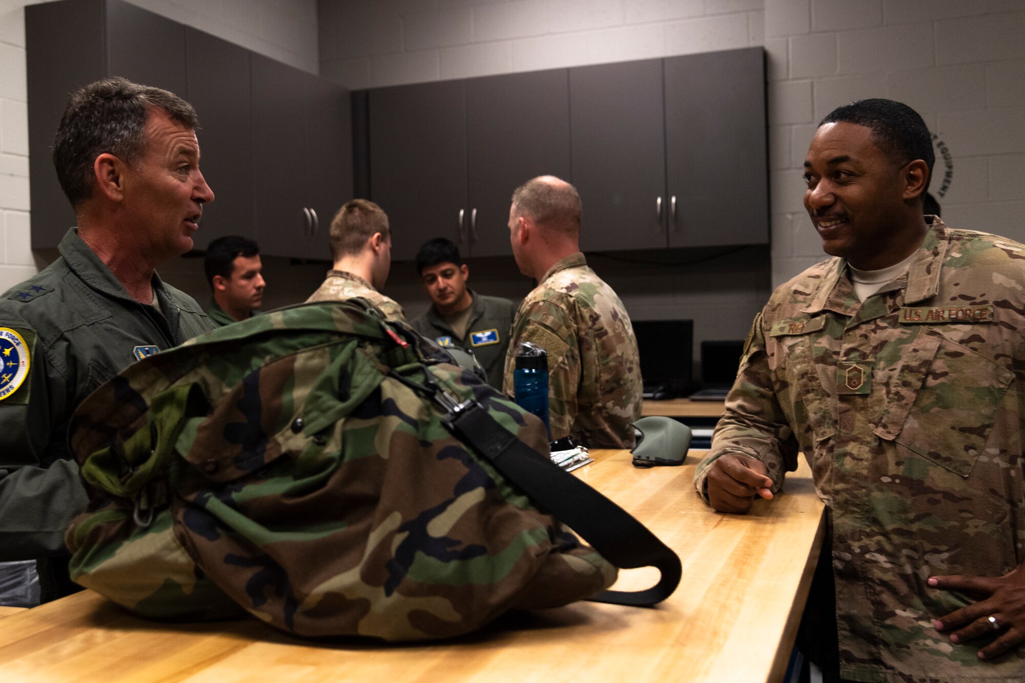 U.S. Air Force Maj. Gen. Chad Franks, left, Ninth Air Force commander, talks with Senior Master Sgt. Dante Rey, 347th Operations Support Squadron superintendent, before a flight at Moody Air Force Base, Ga., Aug. 8, 2019. It was Franks’ initial flight in the Ninth Air Force commander’s flagship aircraft, an HH-60G Pave Hawk assigned to the 41st Rescue Squadron. Franks, who on separate occasions served as the commander for the 23d Wing and 347th Rescue Group, is a command pilot with more than 3,300 hours in multiple aircraft including HC-130J Combat King II and HH-60G Pave Hawk. (U.S. Air Force photo by Airman 1st Class Taryn Butler)