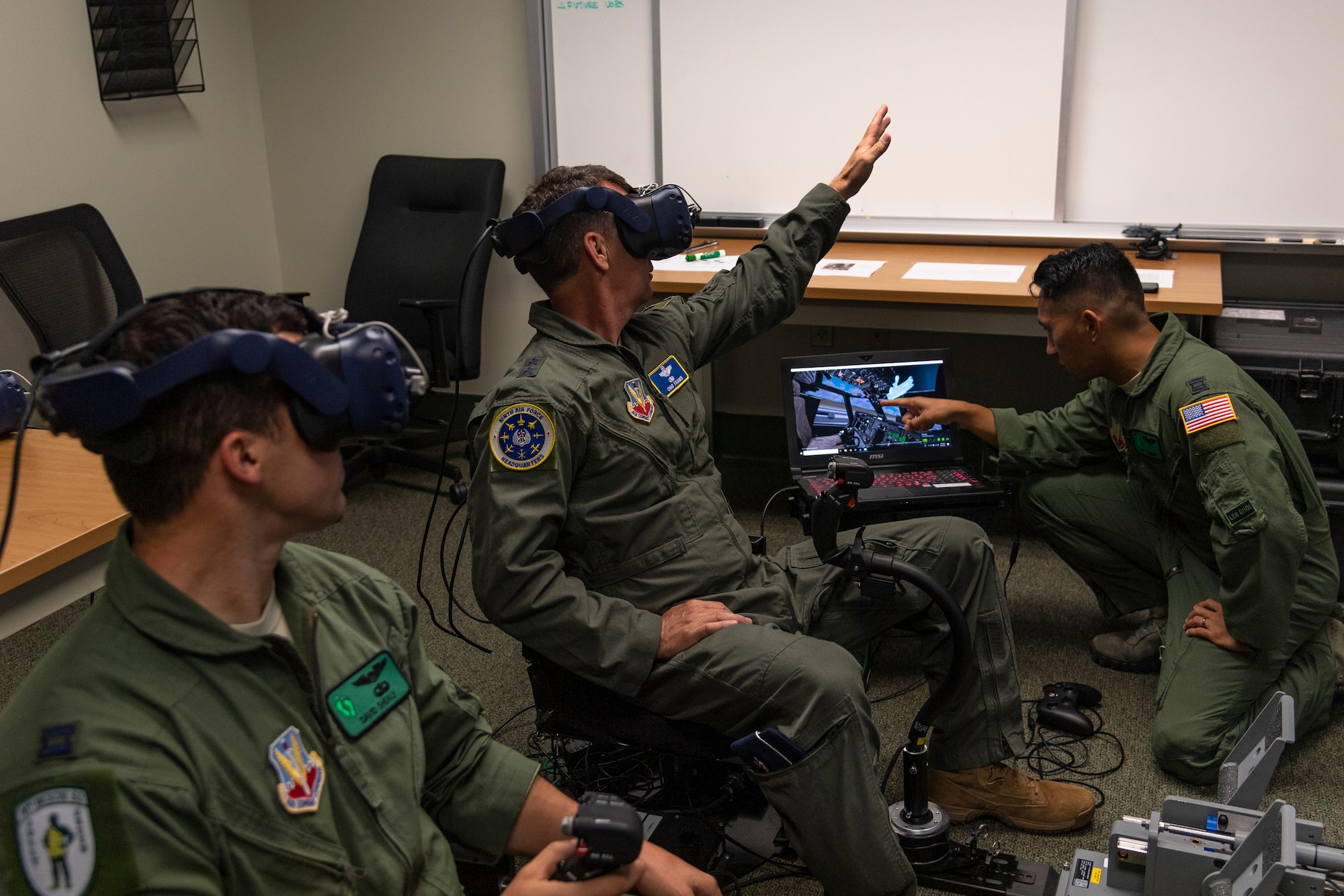 U.S. Air Force Maj. Gen. Chad Franks, center, Ninth Air Force commander, tests the 41st Rescue Squadron’s (RQS) virtual reality flight simulator before a flight at Moody Air Force Base, Ga., Aug. 8, 2019. It was Franks’ initial flight in the Ninth Air Force commander’s flagship aircraft, an HH-60G Pave Hawk assigned to the 41st RQS. Franks, who on separate occasions served as the commander for the 23d Wing and 347th Rescue Group, is a command pilot with more than 3,300 hours in multiple aircraft including HC-130J Combat King II and HH-60G Pave Hawk. (U.S. Air Force photo by Airman 1st Class Taryn Butler)