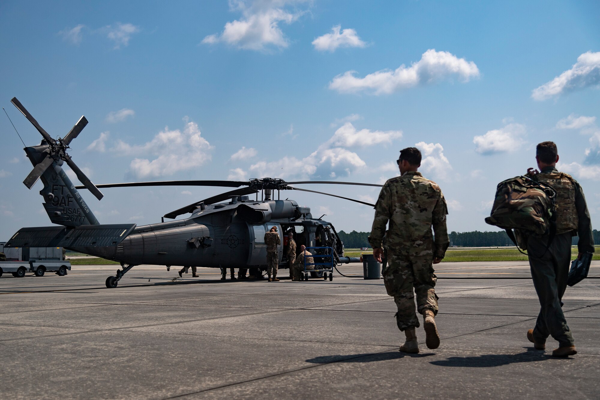 U.S. Air Force Maj. Gen. Chad Franks, right, Ninth Air Force commander, and Maj. Eric Cranford, 723d Aircraft Maintenance Squadron maintenance operations office, walks the flightline to an HH-60G Pave Hawk at Moody Air Force Base, Ga., Aug. 8, 2019. It was Franks’ initial flight in the Ninth Air Force commander’s flagship aircraft, an HH-60G Pave Hawk assigned to the 41st Rescue Squadron. Franks, who on separate occasions served as the commander for the 23d Wing and 347th Rescue Group, is a command pilot with more than 3,300 hours in multiple aircraft including HC-130J Combat King II and HH-60G Pave Hawk. (U.S. Air Force photo by Airman 1st Class Taryn Butler)