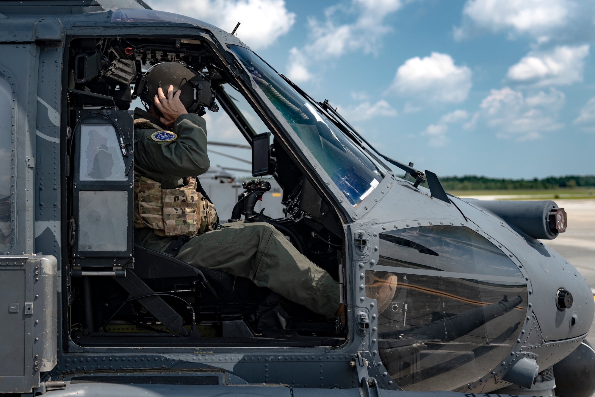 U.S. Air Force Maj. Gen. Chad Franks, Ninth Air Force commander, dons a helmet in an HH-60G Pave Hawk before a flight at Moody Air Force Base, Ga., Aug. 8, 2019. It was Franks’ initial flight in the Ninth Air Force commander’s flagship aircraft, an HH-60G Pave Hawk assigned to the 41st Rescue Squadron. Franks, who on separate occasions served as the commander for the 23d Wing and 347th Rescue Group, is a command pilot with more than 3,300 hours in multiple aircraft including HC-130J Combat King II and HH-60G Pave Hawk. (U.S. Air Force photo by Airman 1st Class Taryn Butler)