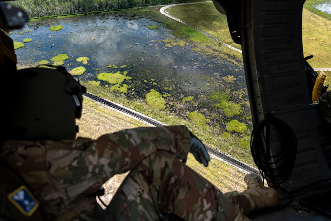 U.S. Air Force Chief Master Sgt. Benjamin Hedden, Ninth Air Force command chief, looks over Grand Bay Range at Moody Air Force Base, Ga., Aug. 8, 2019. Hedden joined U.S. Air Force Maj. Gen. Chad Franks, Ninth Air Force commander, for the initial flight in Franks’ flagship aircraft, an HH-60G Pave Hawk assigned to the 41st Rescue Squadron. Franks, who on separate occasions served as the commander for the 23d Wing and 347th Rescue Group, is a command pilot with more than 3,300 hours in multiple aircraft including HC-130J Combat King II and HH-60G Pave Hawk. (U.S. Air Force photo by Airman 1st Class Taryn Butler)