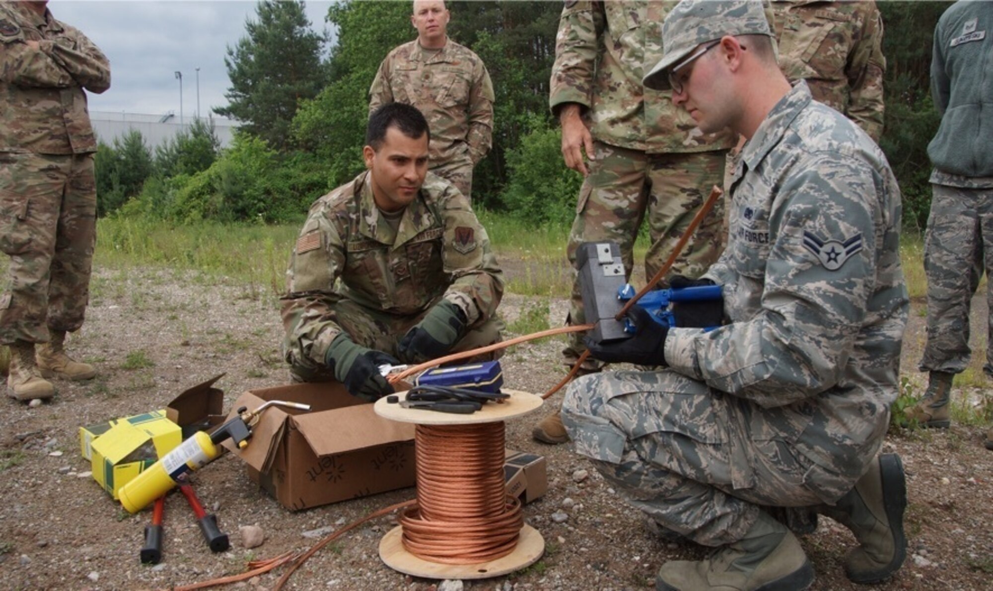 U.S. Air Force Senior Amn. Jorge Lizardi, 235th Air Traffic Controller Squadrons (ATCS) and Airman 1st Class Gabriel Archambault, 260th ATCS receive cad welding training in Ramstein, Germany, June. 4th, 2019. The North Carolina Air National Guard, along with New Hampshire and Maine Air National Guard, flew to Ramstein Air Base, Germany to work with active duty 1st Combat Communications Squadron. The Air National Guard units assisted in training the active duty unit with set-up, use, and tear-down of a mobile tower and deployable tactical air navigation system. (Courtesy Photo by SrA Tsua Yang)