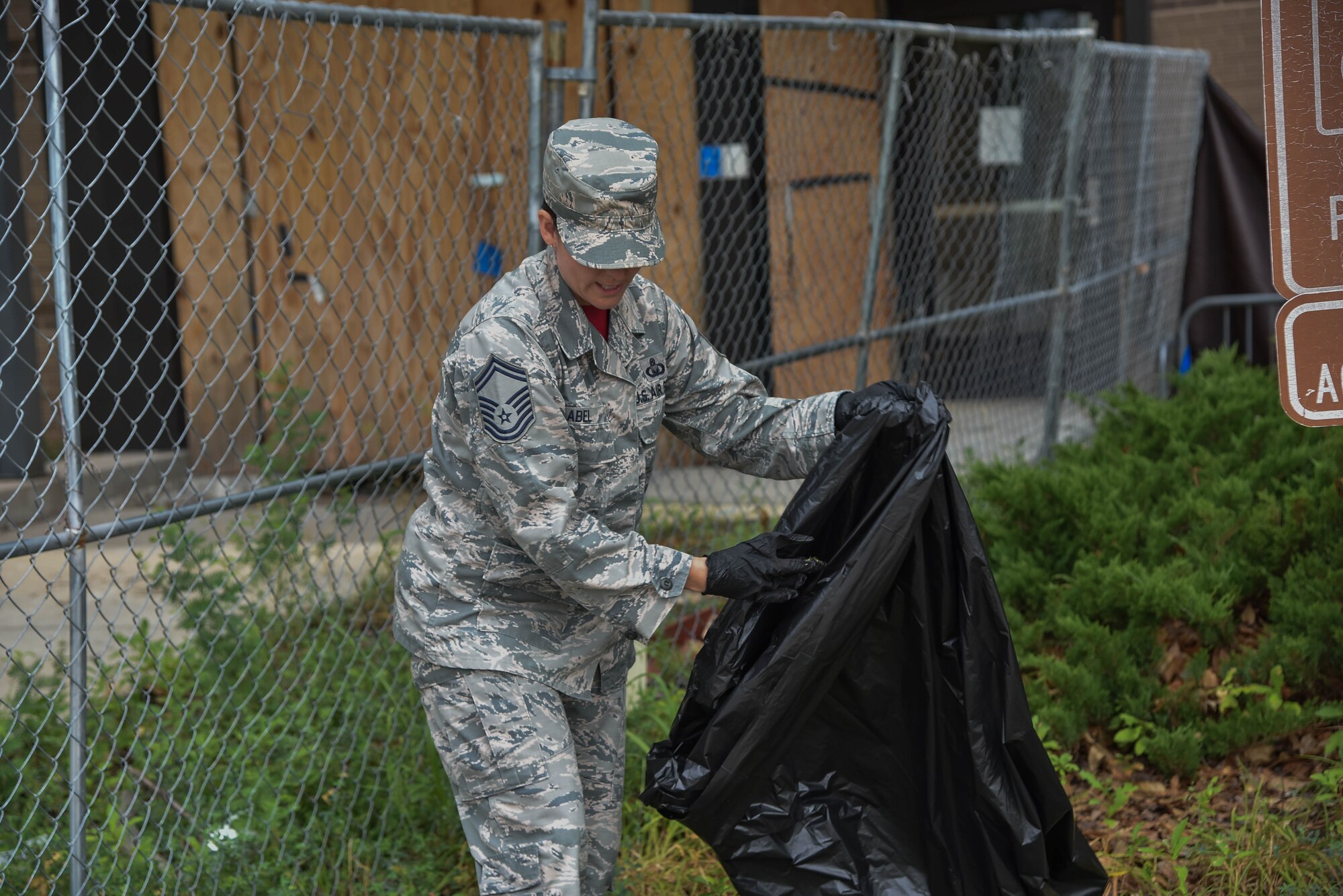 Senior Master Sgt. Jennifer Abel, 22nd Force Support Squadron Airman Leadership School commandant, leads a group of Airmen beautifying the base around the  Dole Center for McConnell Pride Day August 9, 2019, at McConnell Air Force Base, Kan. Airmen of all ranks took time out of their day to participate in McConnell’s Pride Day, evenly distributing the workload. (U.S. Air Force photo by Airman 1st Class Marc A. Garcia)
