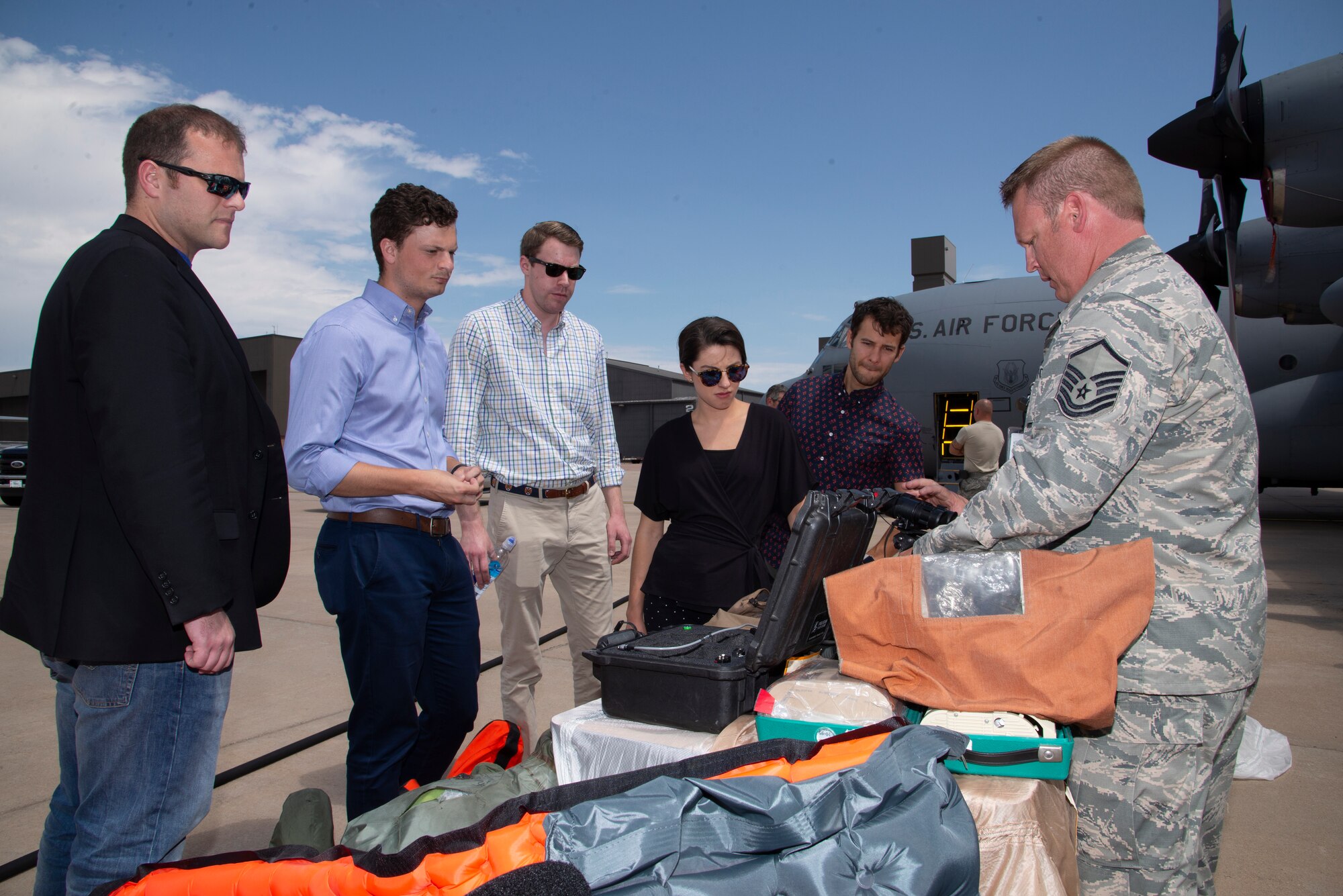 Master Sgt. Brent Renholm, a 302nd Aircrew Flight Equipment flight chief, explains how 302nd Airlift Wing aircrew use the equipment maintained by his shop to congressional staffers during their visit at Peterson Air Force Base, Colorado, Aug. 7, 2019.