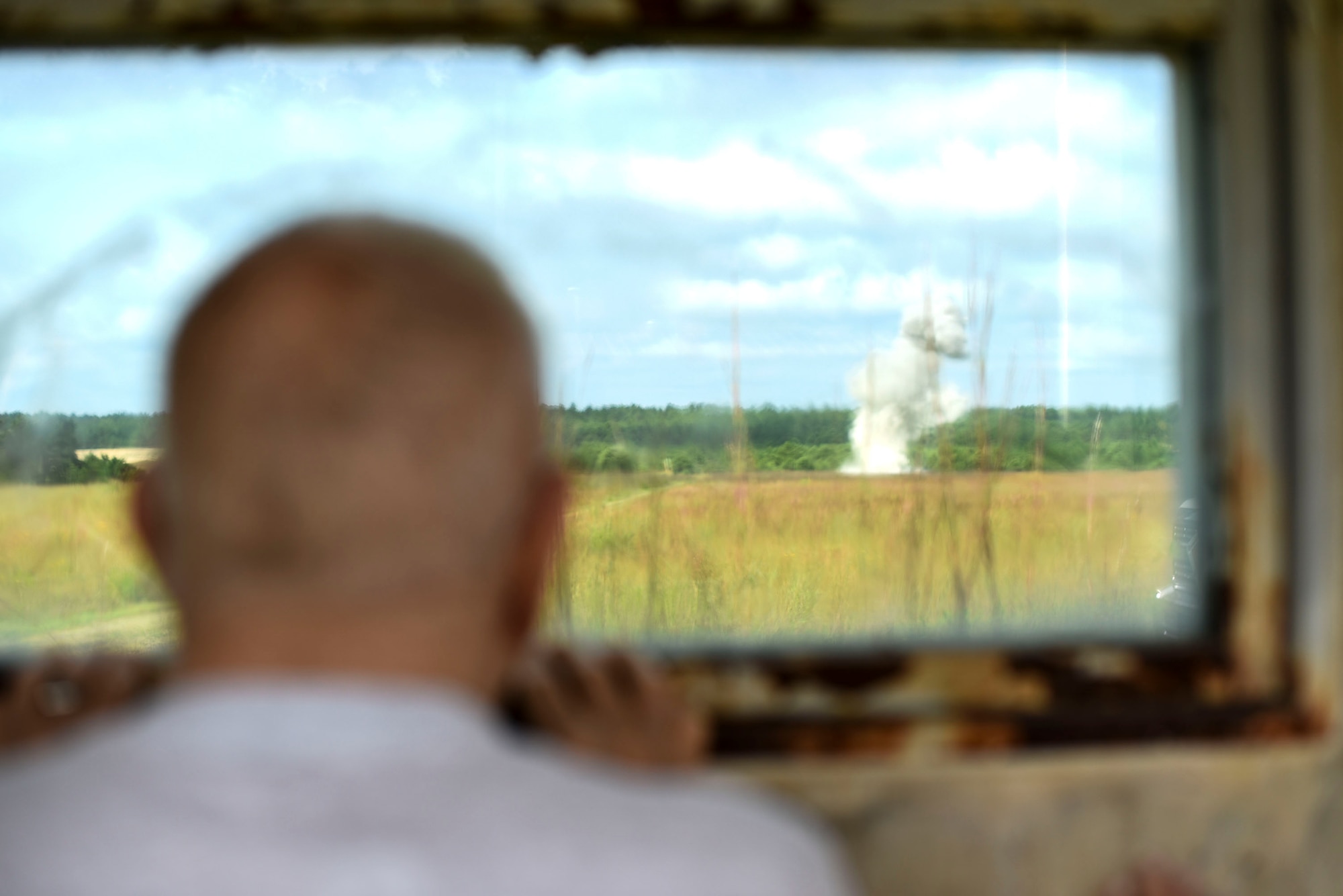 John “Jack” McCarthy, retired U.S. Air Force Explosive Ordnance Disposal technician, watches a controlled detonation on the EOD proficiency range during a tour with the 87th Civil Engineer Squadron EOD team on Joint Base McGuire-Dix-Lakehurst, New Jersey, Aug. 7, 2019. McCarthy served for four years during the Korean War before getting out and settling down with his wife Claire. (U.S. Air Force photo by Airman 1st Class Ariel Owings)