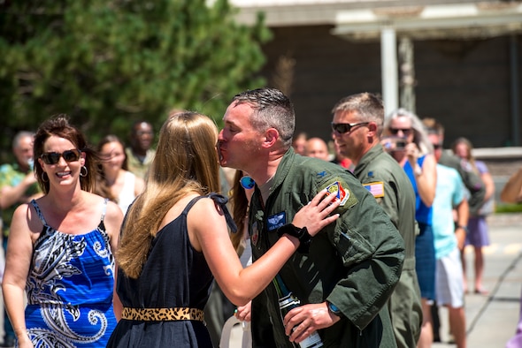 Col. Thomas Palmer, 366th Fighter Wing chief of staff, kisses his daughter's cheek, Aug. 2, 2019 at Mountain Home Air Force Base, Idaho. Palmer flew his last flight within an F-15E before retiring from the U.S. Air Force. (U.S. Air Force photo by Airman 1st Class Eric Brown)
