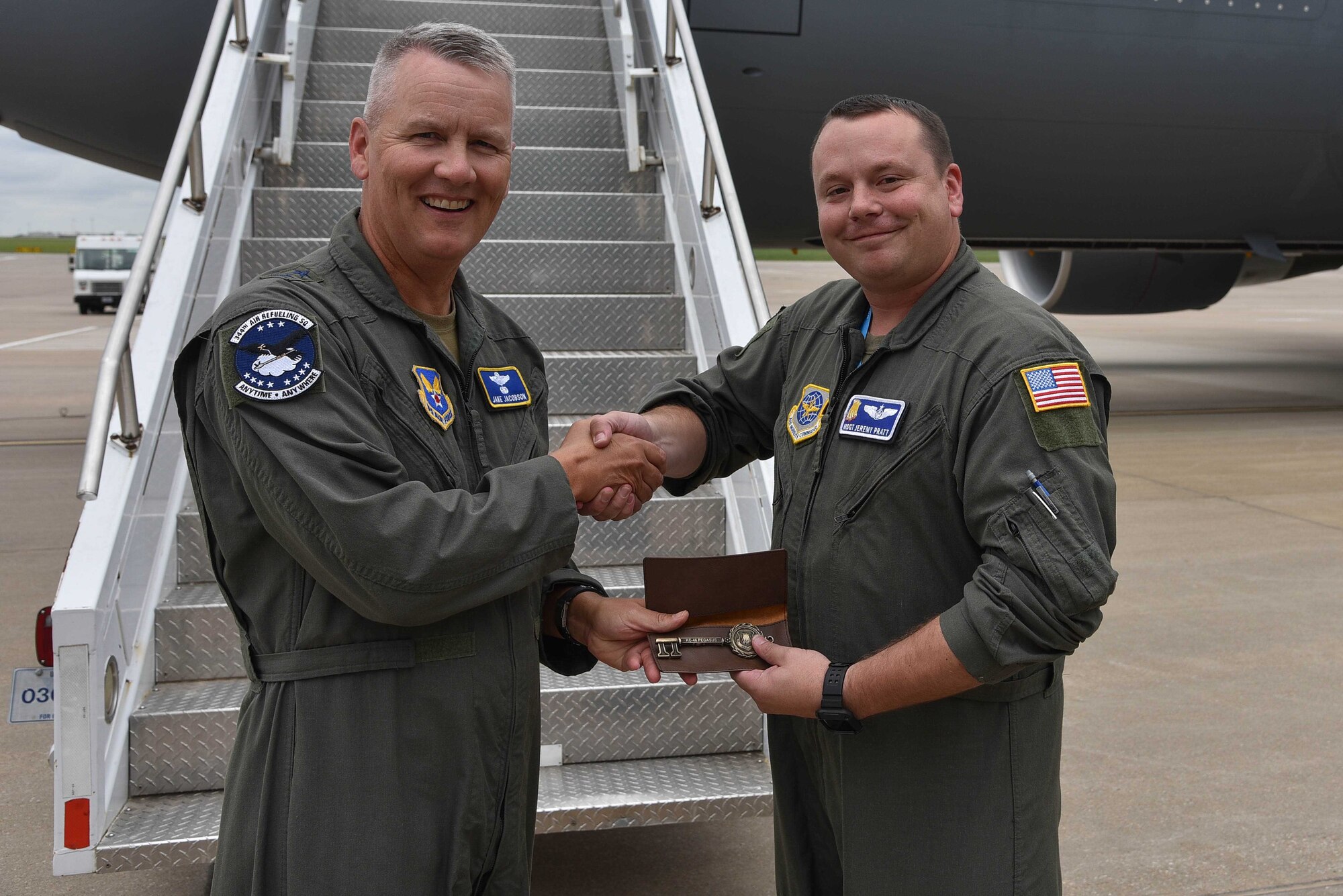 Master Sgt. Jeremy Pratt, 344th Air Refueling Squadron chief boom operator presents the keys of the aircraft to Maj. Gen. James Jacobson, Headquarters Air Force director of training and deputy chief of staff for operations, plans and requirements, August 9, 2019, McConnell Air Force Base, Kan. The installation continues to assist the integration of the next generation air mobility platform. (U.S. Air Force photo by Airman 1st Class Marc A. Garcia)