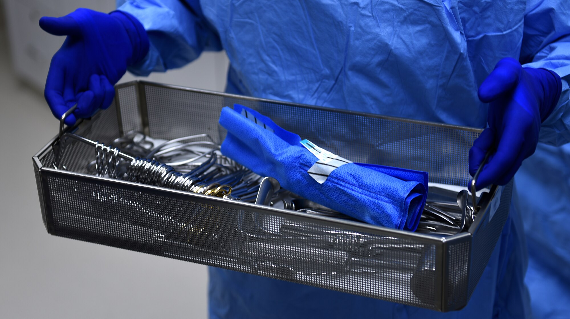 U.S. Air Force Col. Zachery Jiron, 60th Air Mobility Wing vice commander, holds an orthopedic instrument tray Aug. 8, 2019, at David Grant USAF Medical Center Travis Air Force Base, California. As part of the Leadership Rounds program, Jiron participated in a simulated surgery to get a firsthand experience of all the precautions medical staff take before every surgery. (U.S. Air Force photo by Airman 1st Class Cameron Otte)