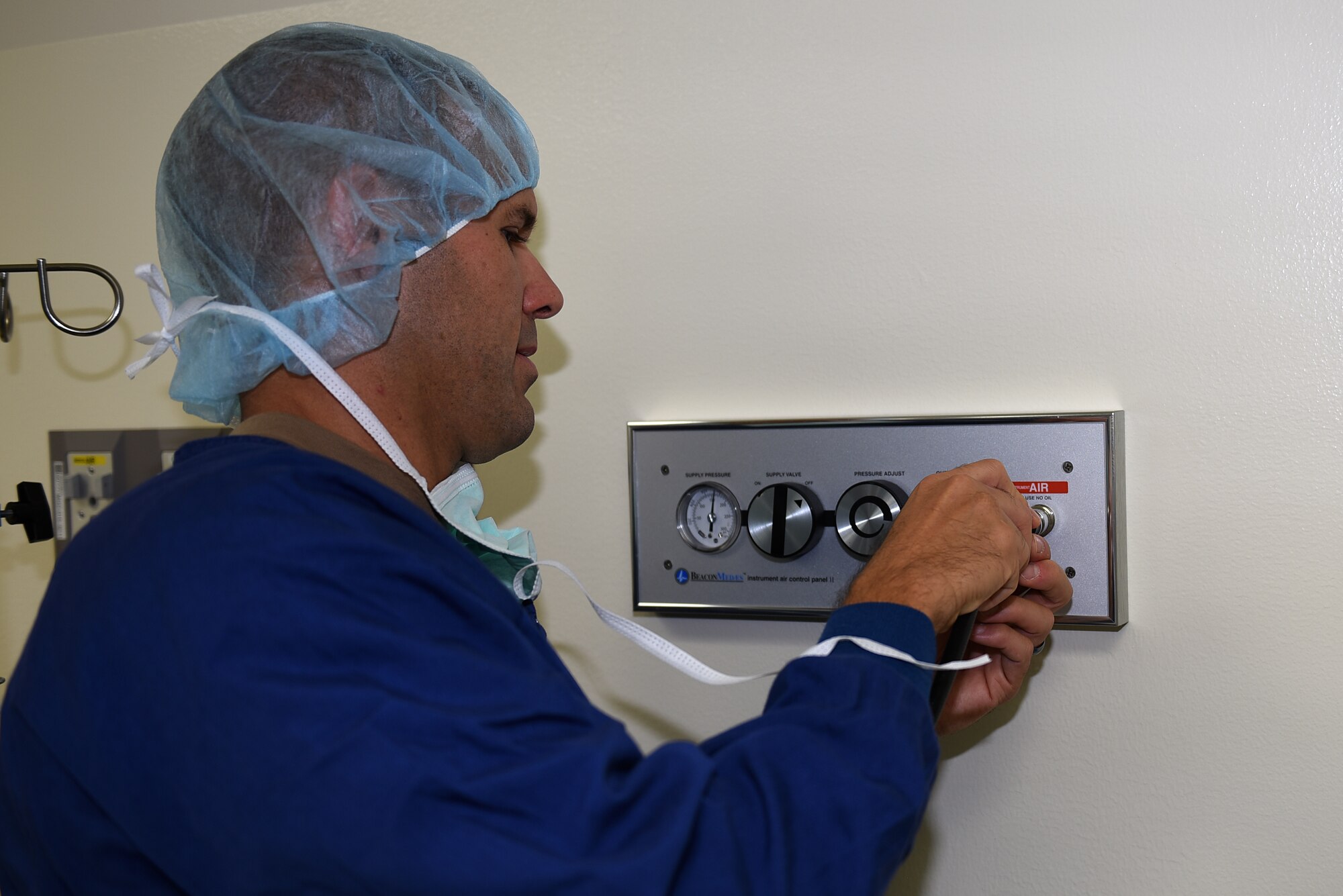 U.S. Air Force Col. Zachery Jiron, 60th Air Mobility Wing vice commander, plugs in the Spider into the pneumatic system to power the Spider’s shoulder positioner Aug. 8, 2019, at David Grant USAF Medical Center Travis Air Force Base, California. The Spider is an operating room piece of equipment that is ideal for the traction of ankle, wrist and elbow procedures. As part of the Leadership Rounds program, Jiron participated in a simulated surgery to get a firsthand experience of all the precautions medical staff take before every surgery. (U.S. Air Force photo by Airman 1st Class Cameron Otte)
