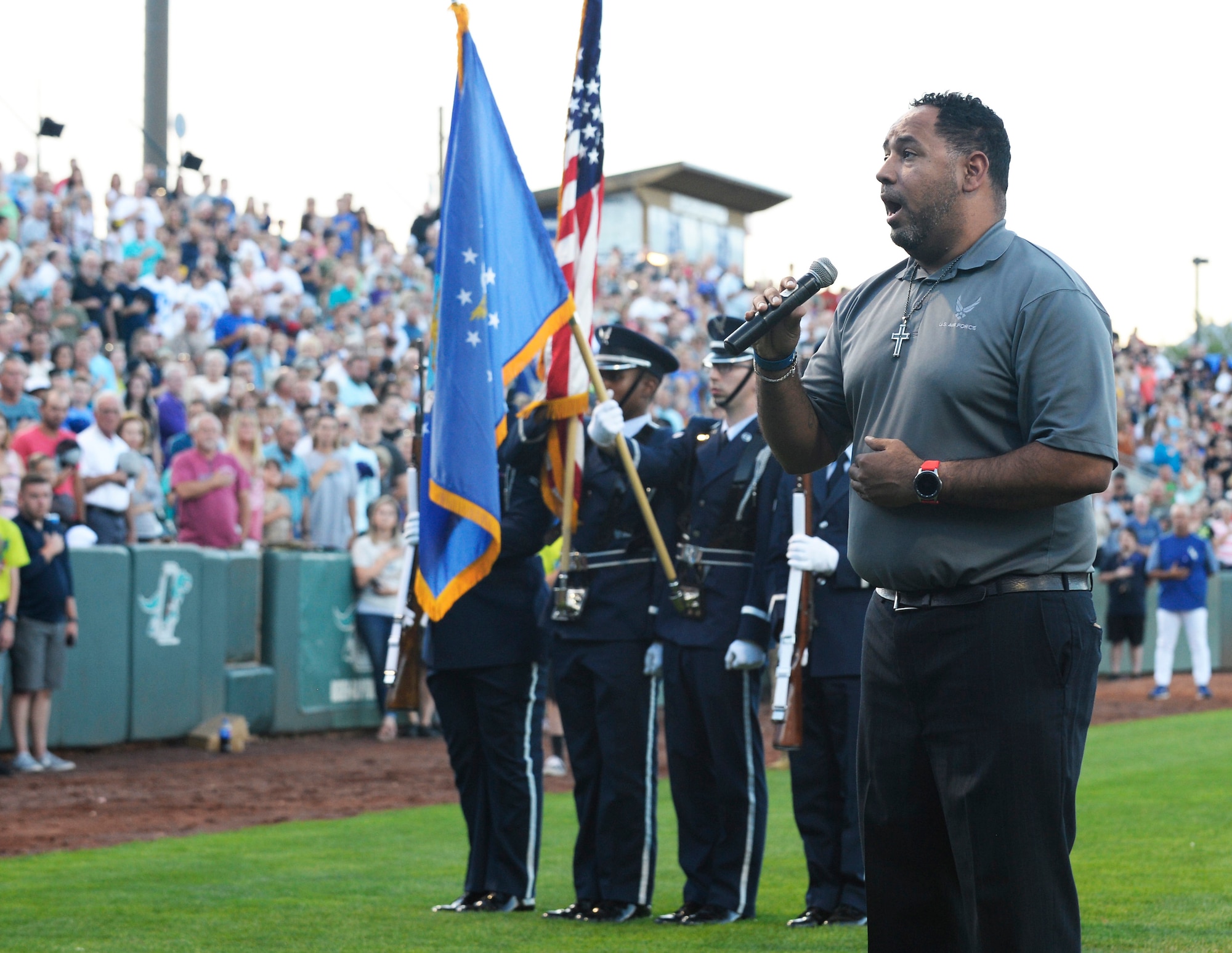 Retired Air Force Staff Sgt. De Andre Boyd sings the national anthem  Aug. 9, 2019, before Military Appreciation Night with the Ogden Raptors and Idaho Falls Chuckars at Lindquist Field in Ogden, Utah. Each year, the Raptors team up with the Top of Utah Military Affairs Committee to offer tickets to Hill Air Force Base personnel and their families. (U.S. Air Force photo by David Perry)