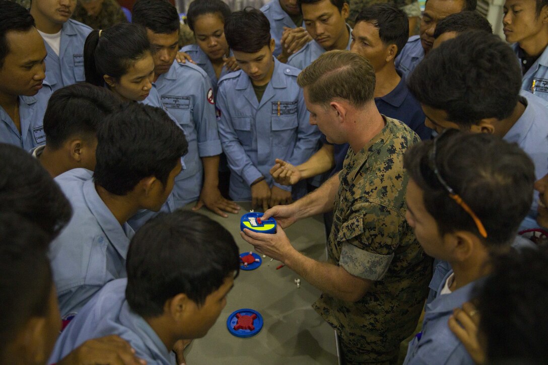 U.S. Marine Corps Sgt. Matthew K. Sponagle explains the components of the Advanced Ordnance Teaching Material during Explosive Ordnance Disposal (EOD) Level 2 instruction for EOD Technicians with Cambodian Mine Action Center during Humanitarian Mine Actions (HMA) Cambodia in Kampong Chhnang, Cambodia, Aug 1, 2019. HMAs are reoccurring events that instruct partner nations’ on tactics, techniques and procedures. This instruction on EOD and tactical combat casualty care capabilities will save lives and relieve human suffering. Sponagle, a native of Reading, Pennsylvania, is an Explosive Ordnance Disposal Technician with 3rd EOD Co., 9th Engineer Support Battalion, 3rd Marine Logistics Group. (U.S. Marine Corps photo by Sgt Stephanie Cervantes)
