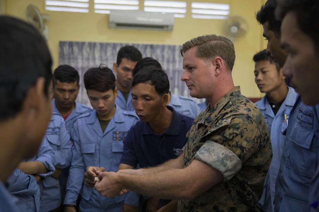 U.S. Marine Corps Sgt. Matthew K. Sponagle explains the components of the Advanced Ordnance Teaching Material during Explosive Ordnance Disposal (EOD) Level 2 instruction for EOD Technicians with Cambodian Mine Action Center during Humanitarian Mine Actions (HMA) Cambodia in Kampong Chhnang, Cambodia, Aug 1, 2019. HMAs are reoccurring events that instruct partner nations’ on tactics, techniques and procedures. This instruction on EOD and tactical combat casualty care capabilities will save lives and relieve human suffering. Sponagle, a native of Reading, Pennsylvania, is an Explosive Ordnance Disposal Technician with 3rd EOD Co., 9th Engineer Support Battalion, 3rd Marine Logistics Group. (U.S. Marine Corps photo by Sgt Stephanie Cervantes)