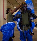 U.S. Marine Corps Lance Cpl. Mikelle A. Thompson, left, assists Cpl. Kendall Jones in putting on his Level-A Fully Encapsulated Chemical Protective Suit at Camp Kinser, Okinawa, Japan, August 1, 2019.  The suit provides the highest level of protection against unknown threats and protects wearers from substances known to damage lungs, skin and eyes. Thompson, a native of Philadelphia, Pennsylvania, and Jones, a native of Mason, Ohio, are both CBRN defense specialists with G-3, Enhanced CBRN Section, Combat Logistics Regiment 37, 3rd Marine Logistics Group. (U.S. Marine Corps photo by Lance Cpl. Carla E. O)
