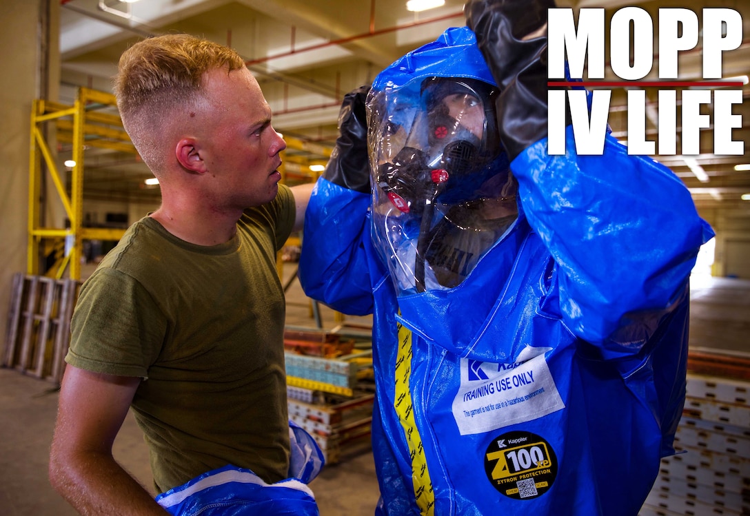 U.S. Marine Corps Lance Cpl. Phoenix Drohan, left, assists Sgt. Cesar Quintero in putting on his Level-A fully encapsulated chemical protective suit at Camp Kinser, Okinawa, Japan, August 1, 2019. The suit provides the highest level of protection against unknown threats and protects wearers from substances known to damage lungs, skin and eyes. Drohan, a native of San Diego, California, and Quintero, a native of Odessa, Texas, are both CBRN defense specialists with G-3, Enhanced CBRN Section, Combat Logistics Regiment 37, 3rd Marine Logistics Group. (U.S. Marine Corps photo by Lance Cpl. Carla E. O)