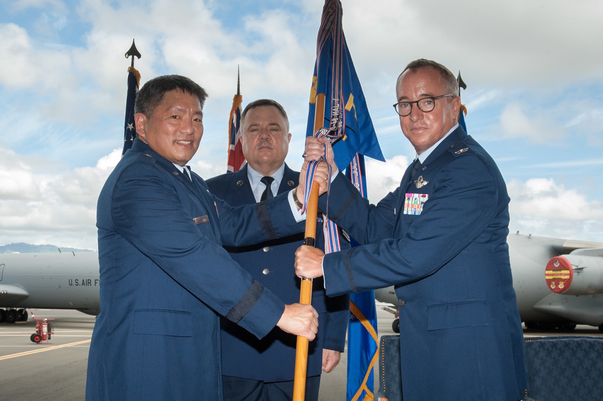 Col. Dann S. Carlson accepts the gaidon flag from Brig. Gen. Ryan T. Okahara, commander of the Hawaii Air National Guard, to symbolize his assumption of command for the 154th Wing Aug. 4, 2019, at Joint Base Pearl Harbor-Hickam.