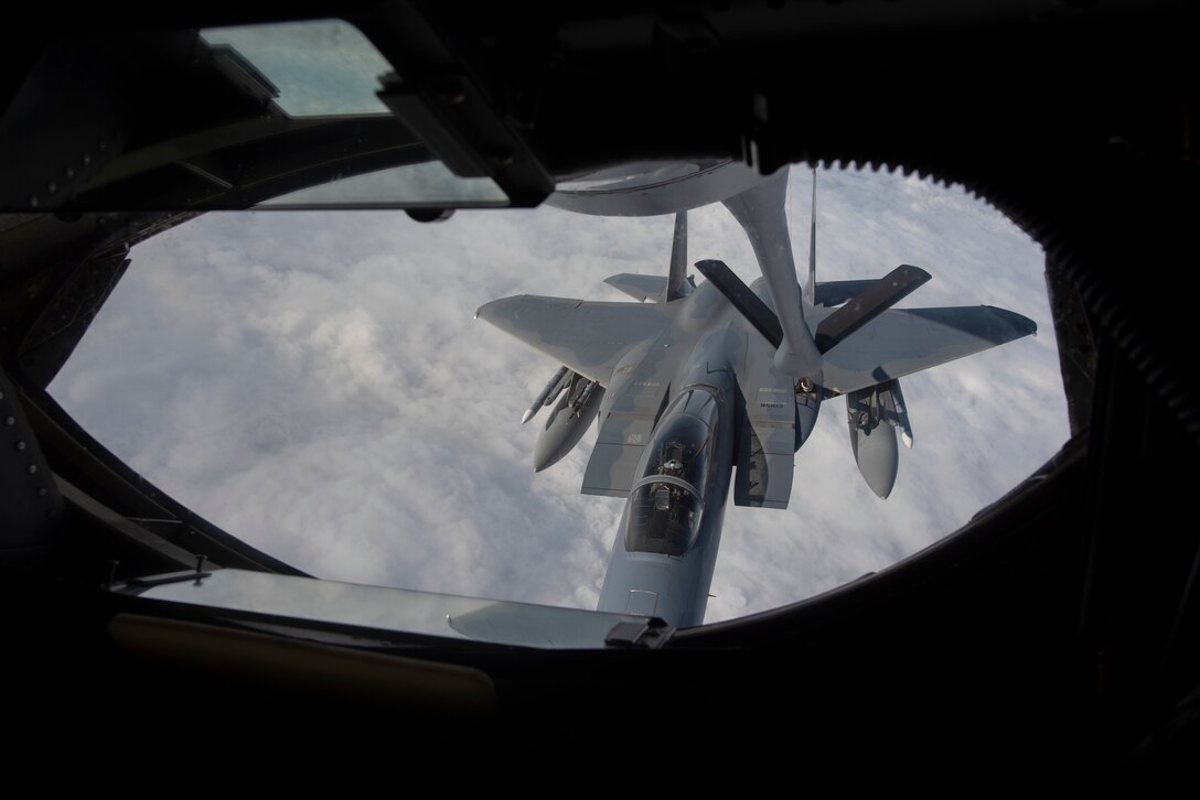 U.S. Air Force Staff Sgt. Andrew Liddane, 909th Air Refueling Squadron boom operator, refuels a 67th Fighter Squadron F-15C Eagle from Kadena Air Base, Japan, during RED FLAG-Alaska 19-3 at Eielson Air Force Base, Alaska, Aug. 7, 2019.
