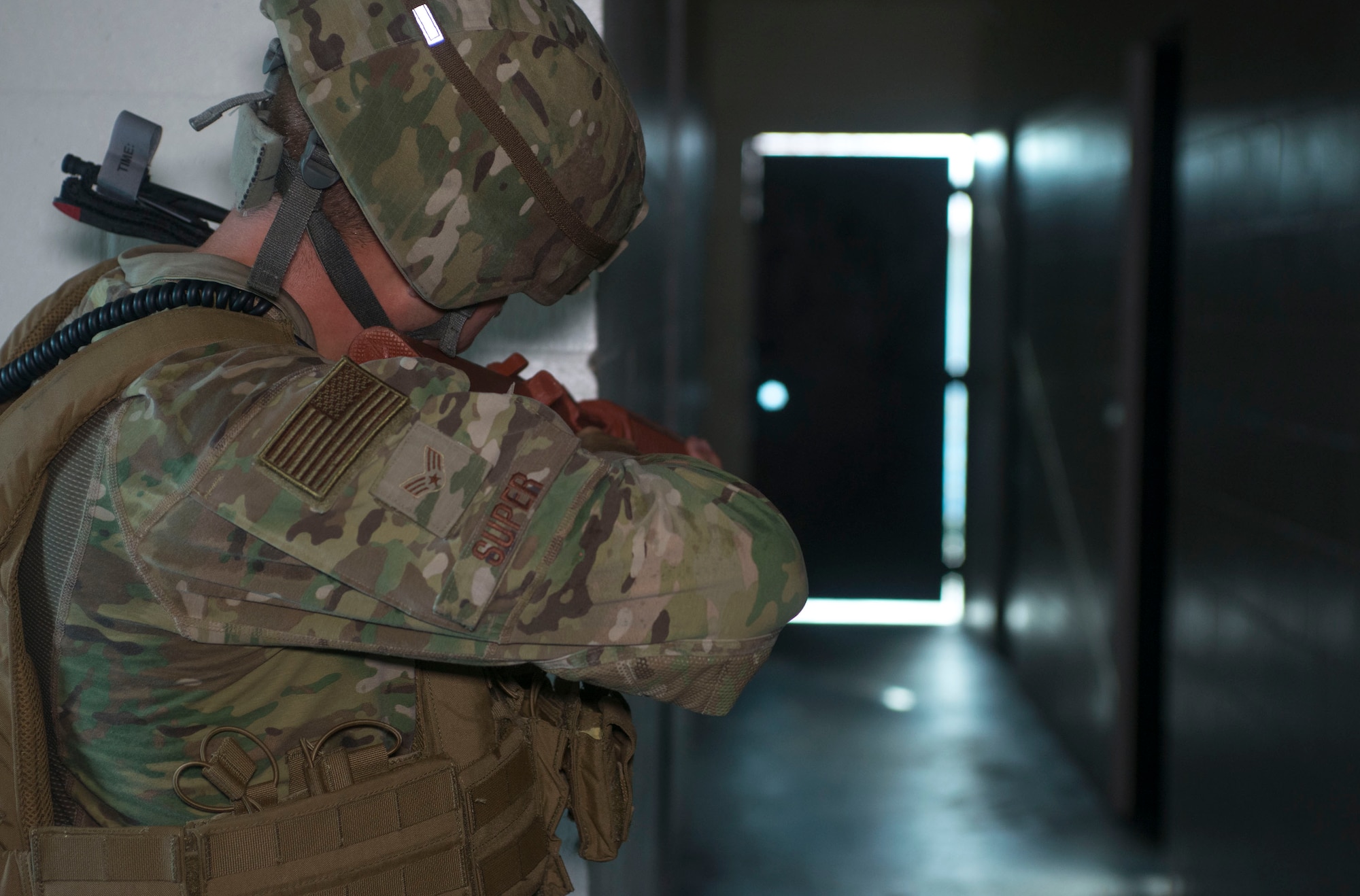 U.S. Air Force Senior Airman Weston Super, a 6th Security Forces Squadron entry controller, aims his training weapon down a hallway during an active shooter exercise at MacDill Air Force Base, Fla., Aug. 8, 2019.