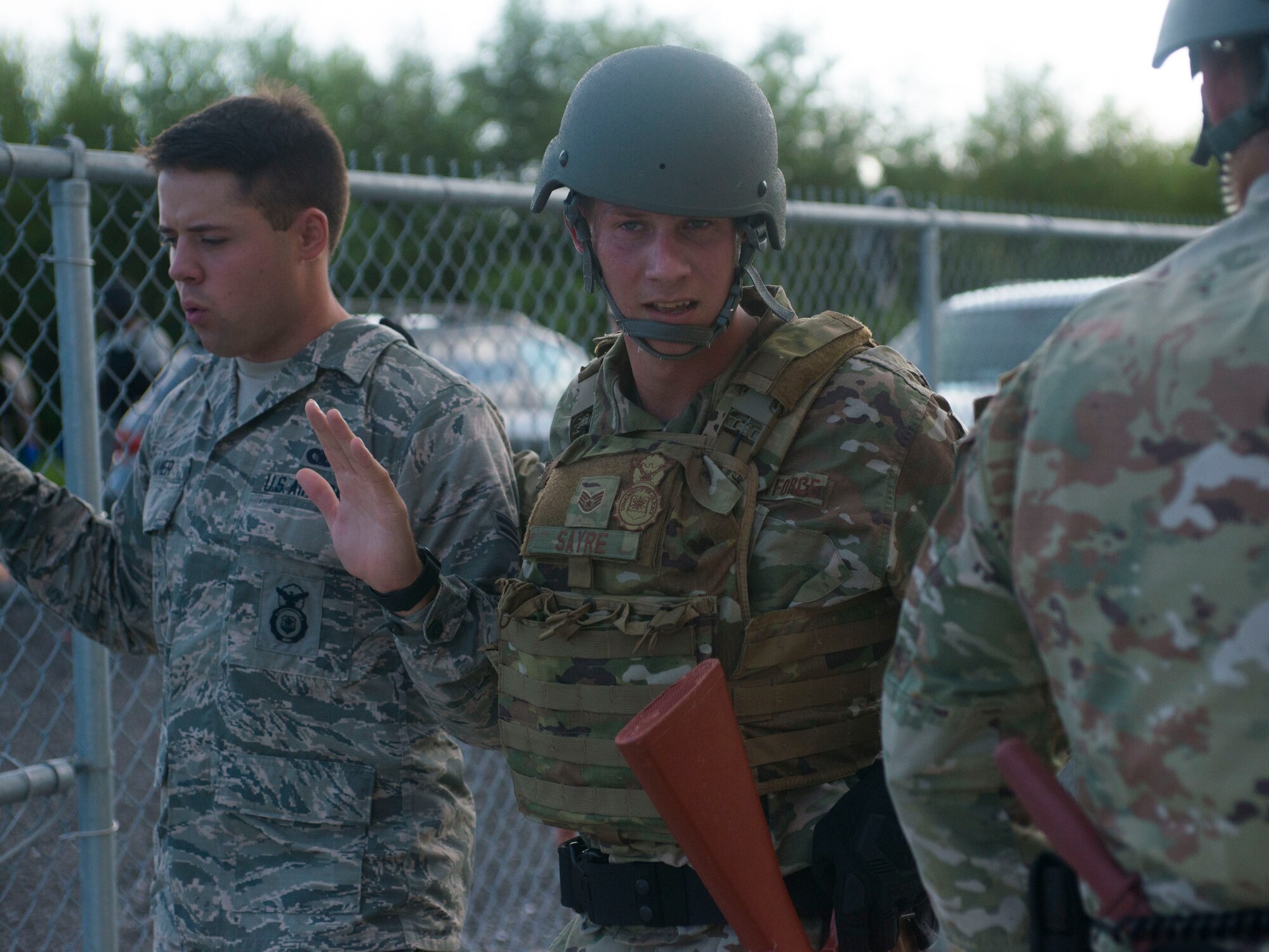 U.S. Air Force Staff Sgt. Michael Sayre, a 6th Security Forces Squadron installation patrolman, escorts the exercise perpetrator during an active shooter exercise at MacDill Air Force Base, Fla., Aug.  8, 2019.