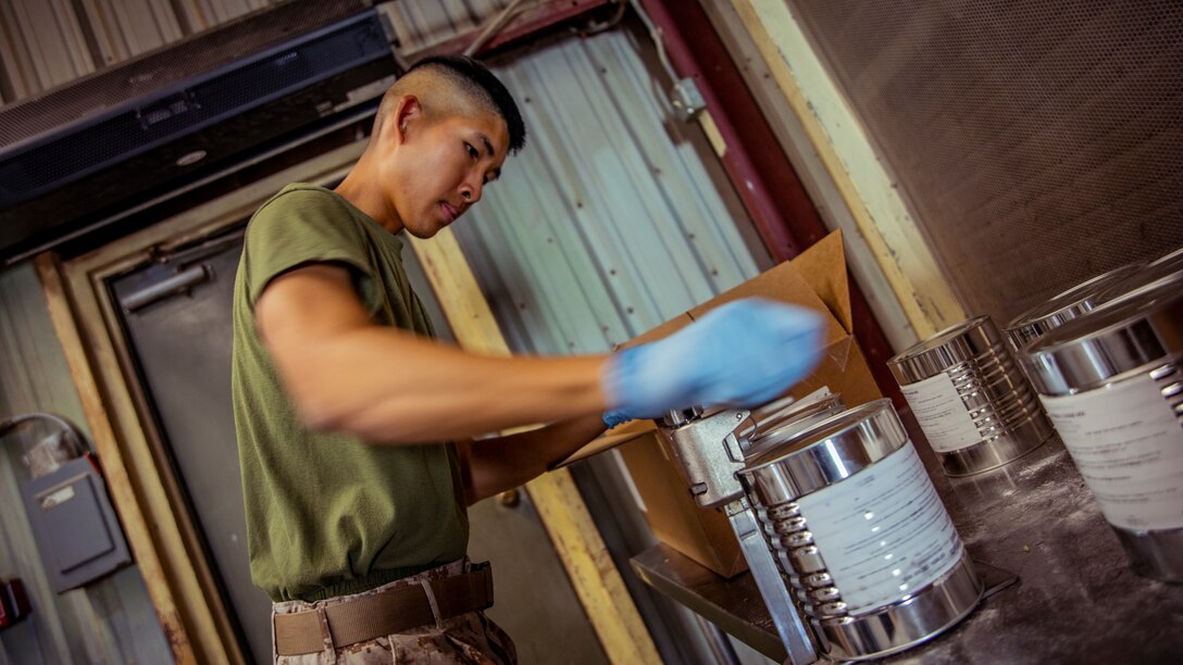U.S. Marine Corps Lance Cpl. Qian Wen, a food service specialist with 1st Battalion, 25th Marine Regiment, 4th Marine Division, unseals a container during Integrated Training Exercise 5-19 at Marine Corps Air Ground Combat Center Twentynine Palms, Calif., Aug. 12, 2019. ITX 5-19 is an essential component of the Marine Forces Reserve’s training and readiness cycle. It serves as the principle exercise for assessing a unit’s capabilities. (U.S. Marine Corps photo by Lance Cpl. Jose Gonzalez)