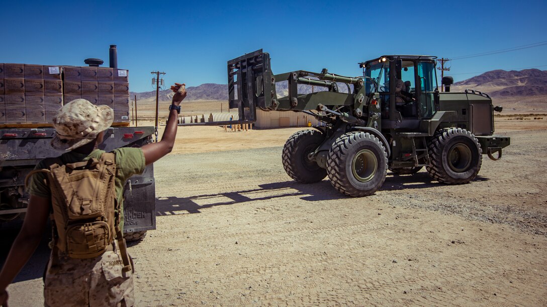 A U.S. Marine with 1st Battalion, 25th Marine Regiment, 4th Marine Division, guides a forklift during Integrated Training Exercise 5-19 at Marine Corps Air Ground Combat Center Twentynine Palms, Calif., Aug. 12, 2019. ITX 5-19 is an essential component of the Marine Forces Reserve’s training and readiness cycle. It serves as the principle exercise for assessing a unit’s capabilities. (U.S. Marine Corps photo by Lance Cpl. Jose Gonzalez)