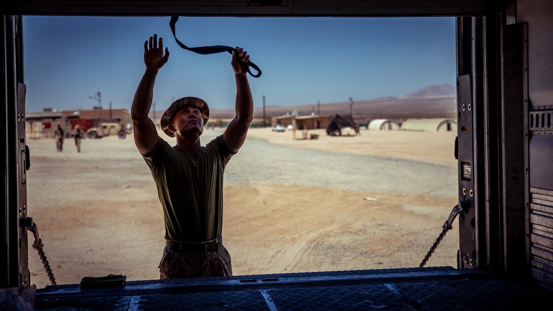 A U.S. Marine with 1st Battalion, 25th Marine Regiment, 4th Marine Division, opens a trailer door during Integrated Training Exercise 5-19 at Marine Corps Air Ground Combat Center Twentynine Palms, Calif., Aug. 12, 2019. ITX 5-19 is an essential component of the Marine Forces Reserve’s training and readiness cycle. It serves as the principle exercise for assessing a unit’s capabilities. (U.S. Marine Corps photo by Lance Cpl. Jose Gonzalez)