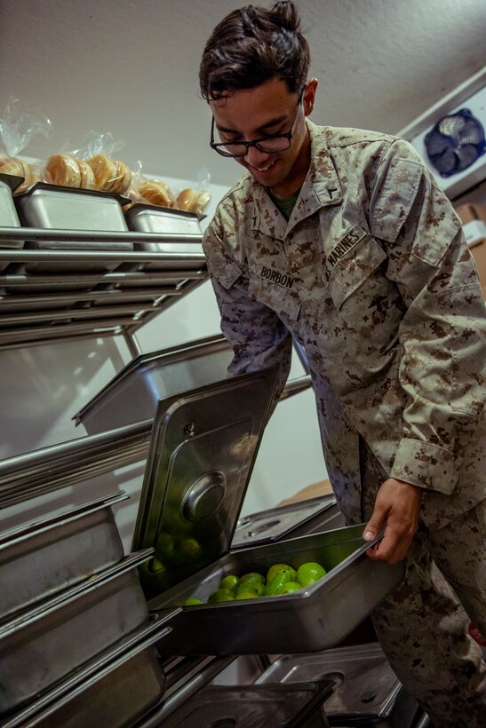 A U.S. Marine with 1st Battalion, 25th Marine Regiment, 4th Marine Division, inspects fruit during Integrated Training Exercise 5-19 at Marine Corps Air Ground Combat Center Twentynine Palms, Calif., Aug. 12, 2019. ITX 5-19 is an essential component of the Marine Forces Reserve’s training and readiness cycle. It serves as the principle exercise for assessing a unit’s capabilities. (U.S. Marine Corps photo by Lance Cpl. Jose Gonzalez)