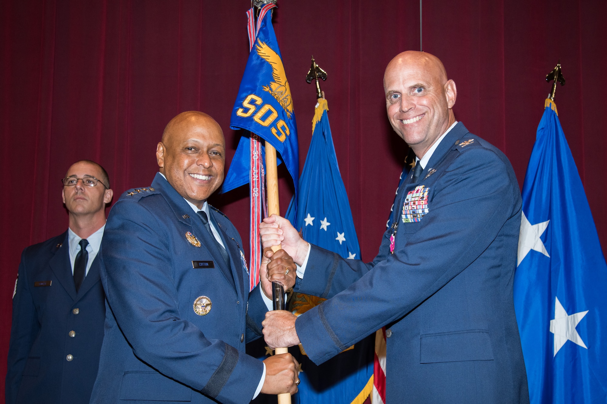 Lt. Gen. Anthony J. Cotton, Air University commander and president, receives the Squadron Officer School guidon from Col. Wayne W. Straw, prior commander and commandant of SOS, during a change of command ceremony August 2, 2019, at Maxwell Air Force Base, Alabama. Straw will be moving on to serve as an instructor at Air University's Air War College.