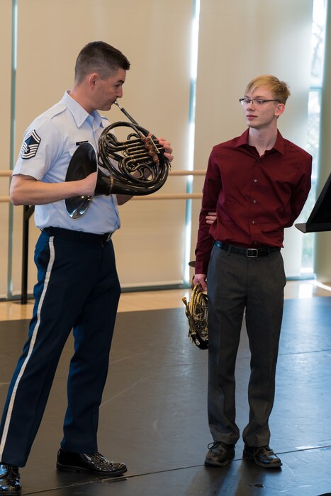 Andrew Stump (right) learns performance techniques from U.S. Air Force Band French hornist, Senior Master Sgt. Brett Miller, during The U.S. Air Force Band's 2019 Collegiate Symposium at the Rachel M. Schlesinger Concert Hall and Arts Center in Alexandria, Virginia. Stump, son of U.S. Air Force Band clarinetist Senior Master Sgt. David Stump, had the privilege of performing with the U.S. Air Force Concert Band as part of the symposium. (U.S. Air Force Photo by TSgt Valentine Lukashuk)
