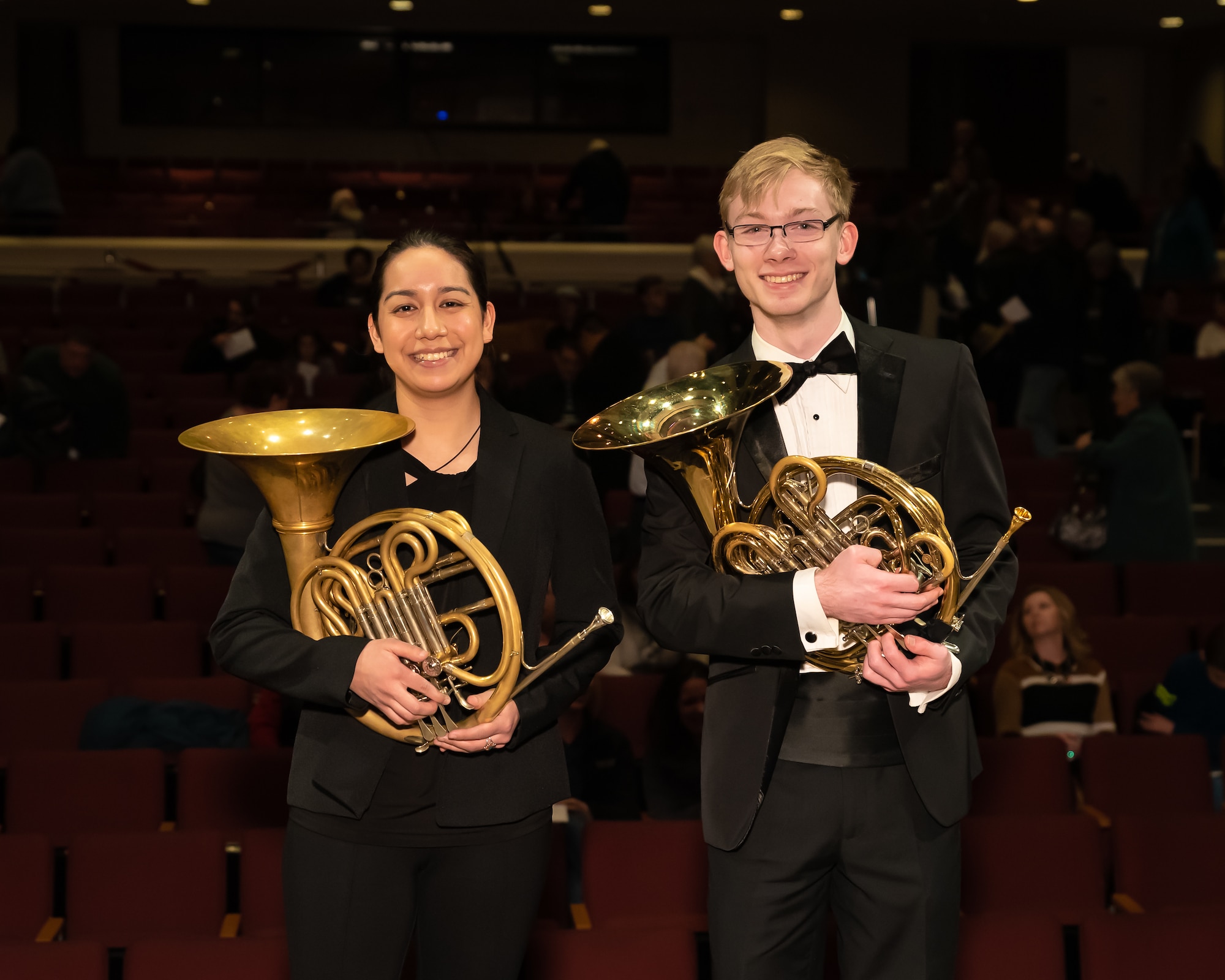 Andrew Stump (right) poses with another French hornist on stage prior to the closing concert of The U.S. Air Force Band's 2019 Collegiate Symposium at the Rachel M. Schlesinger Concert Hall and Arts Center in Alexandria, Virginia. Stump, son of U.S. Air Force Band clarinetist Senior Master Sgt. David Stump, had the privilege of performing with the U.S. Air Force Concert Band as part of the symposium. (U.S. Air Force Photo by MSgt Brandon Chaney)