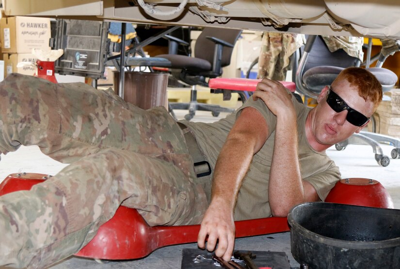 Sgt. Dallas Rohlick, a motor transport operator, attached to 38th Infantry Division drains fluids from a light medium tactical vehicle for turn in August 9, 2019 in Kuwait keeping Task Force Spartan ready for any mission.