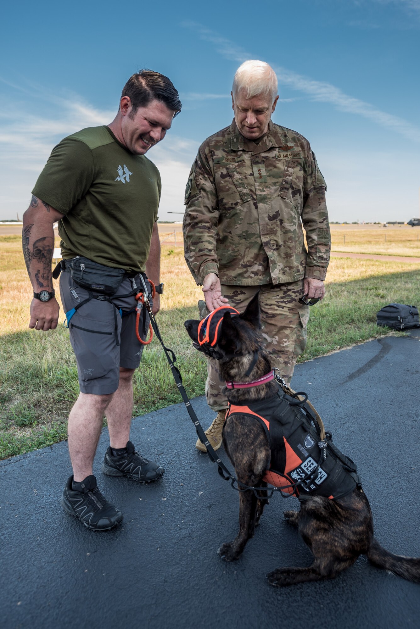 Lt. Gen. L. Scott Rice (right), director of the Air National Guard, meets Callie, the only search-and-rescue dog in the Department of Defense, and her handler, Master Sgt. Rudy Parsons, a pararescueman in the 123rd Special Tactics Squadron, during a visit to the Kentucky Air National Guard Base in Louisville, Ky. Aug. 10, 2019. (U.S. Air National Guard photo by Lt. Col. Dale Greer)