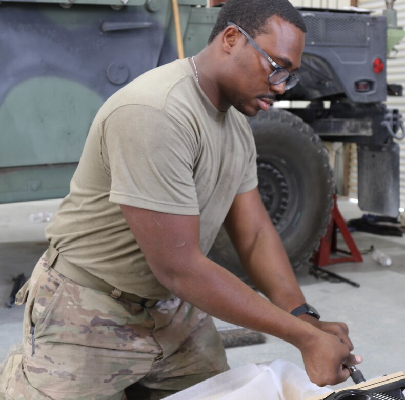 Spc. Hunter Carlos, a motor transport operator, 38th Infantry Division installs new windows on a high mobility multipurpose wheeled vehicle that had delaminated windows causing poor visibility, August 9, 2019 in Kuwait keeping Task Force Spartan's wheels rolling along and ready.