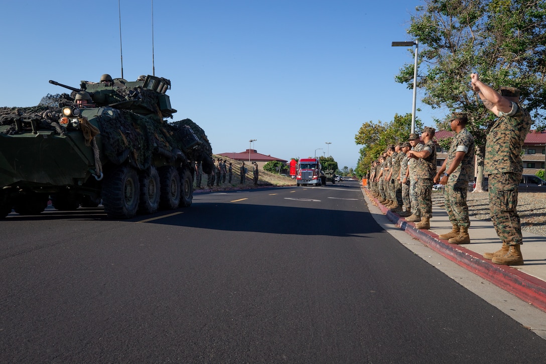 U.S. Marines with 1st Light Armored Reconnaissance (LAR) Battalion, 1st Marine Division, line the streets to give the Highlander salute during the arrival of the 1st LAR monument at Camp Pendleton, Calif., July 24, 2019. The 1st LAR Marines were nicknamed the “Highlanders” in honor of the famous Scottish Soldiers of the past. The monument was donated by the 1st LAR Association in honor of their fallen brothers and proudly escorted by Marines with 1st LAR. (U.S. Marine photo by Sgt. Tayler P. Schwamb)