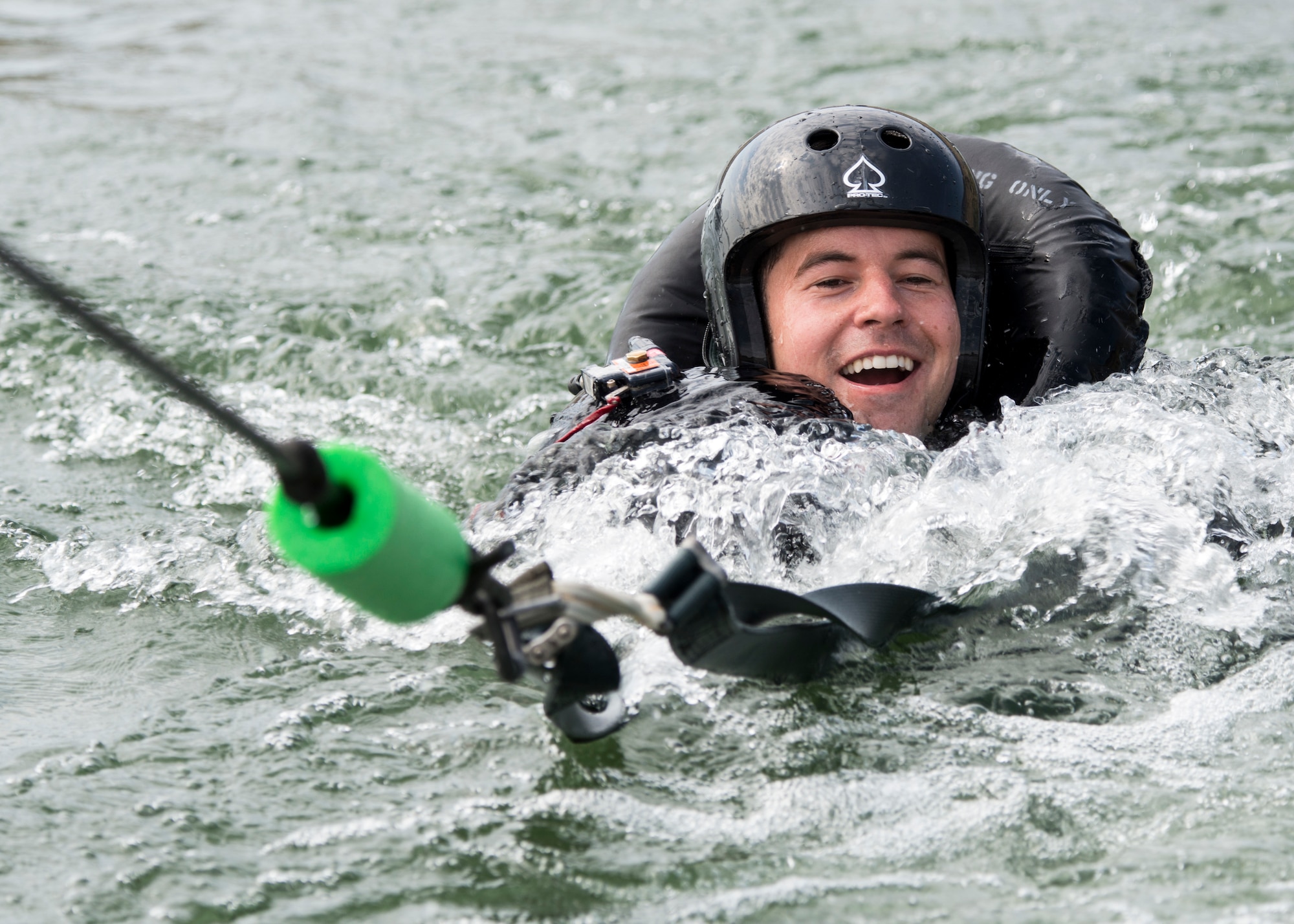 A 389th Fighter Squadron aircrew member is dragged behind a boat during water survival training Aug. 06, 2019, at C.J. Strike Reservoir, Idaho. This portion of the training allows pilots to practice unhooking the parachute from the safety harness as they are dragged by the wind. (U.S. Air Force photo by Airman Antwain L. Hanks)