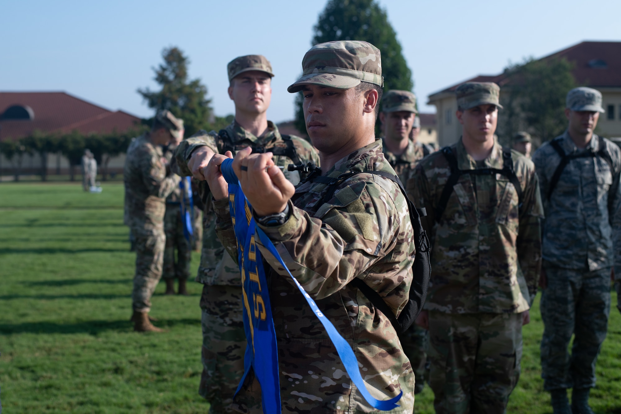 An officer trainee puts his flight’s newly earned pennant on their guide-on, Aug. 9, 2019, on Maxwell Air Force Base, Alabama. The pennant ceremony marked the end of the classes second week of training. (U.S. Air Force photo by Airman 1st Class Charles Welty)