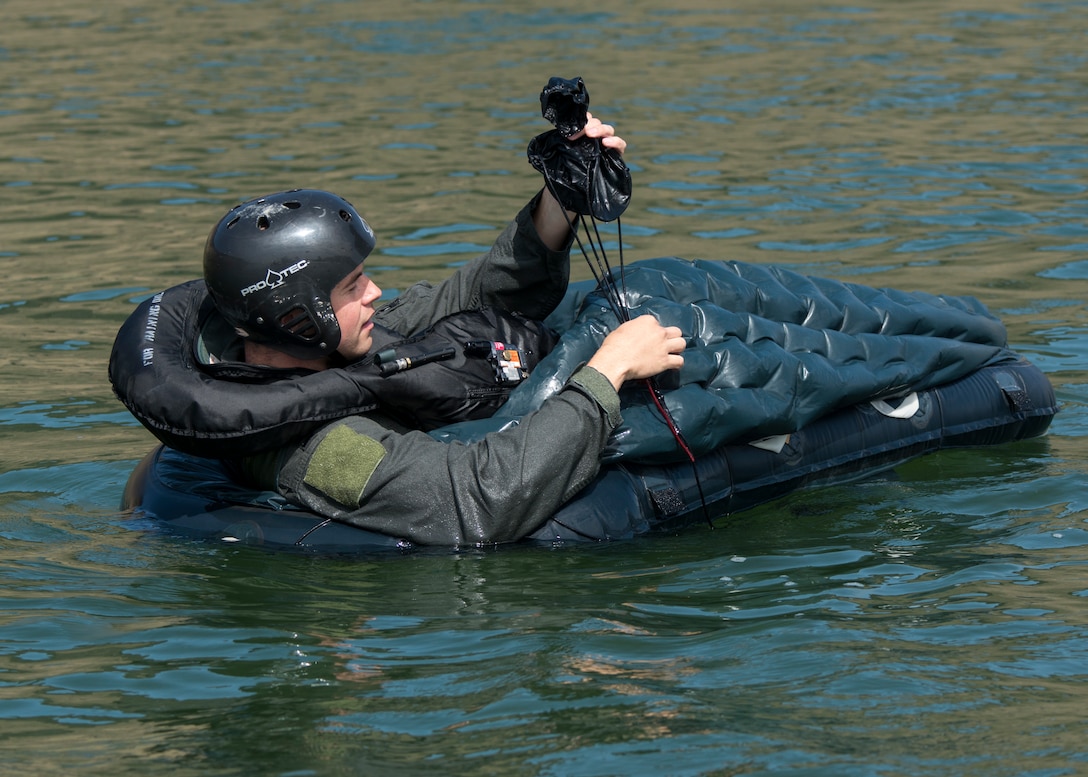 A 389th Fighter Squadron aircrew member pulling in his anchor to prep from sea extraction, Aug. 06, 2019 at C.J. Strike Reservoir, Idaho. Aircrew have multiple tools such as reflectors and strobe lights that can be used to signal other ships. (U.S. Air Force photo by Airman Antwain L. Hanks)