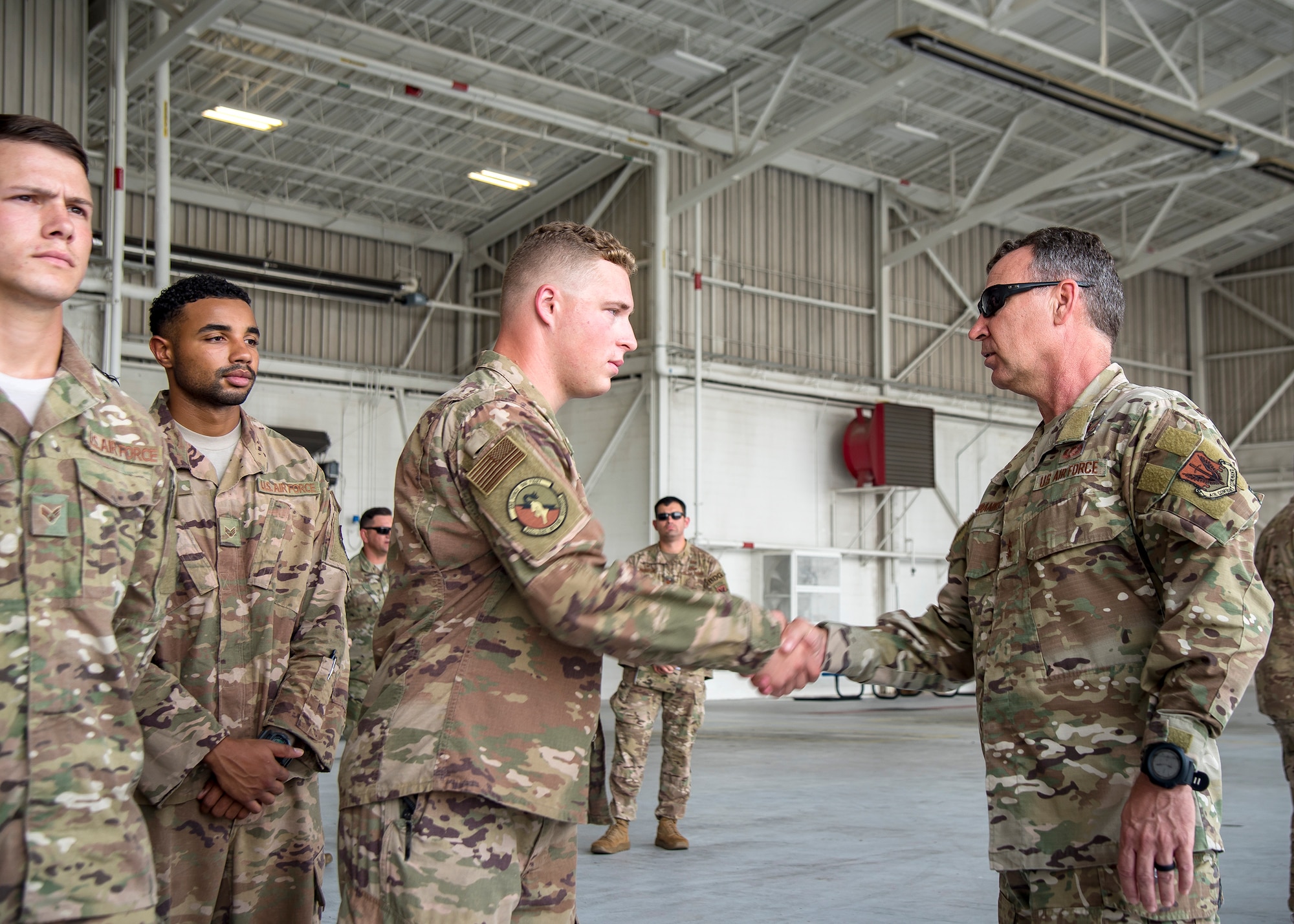Maj. General Chad Franks, right, Ninth Air Force commander, coins an Airman from the 820th Base Defense Group Aug. 9, 2019, at Moody Air Force Base, Ga. Franks, who on separate occasions served as the commander for the 23d Wing and 347th Rescue Group, is a command pilot with more than 3,300 hours in multiple aircraft including HC-130J Combat King II and HH-60G Pave Hawk. (U.S. Air Force photo by Airman 1st Class Eugene Oliver)