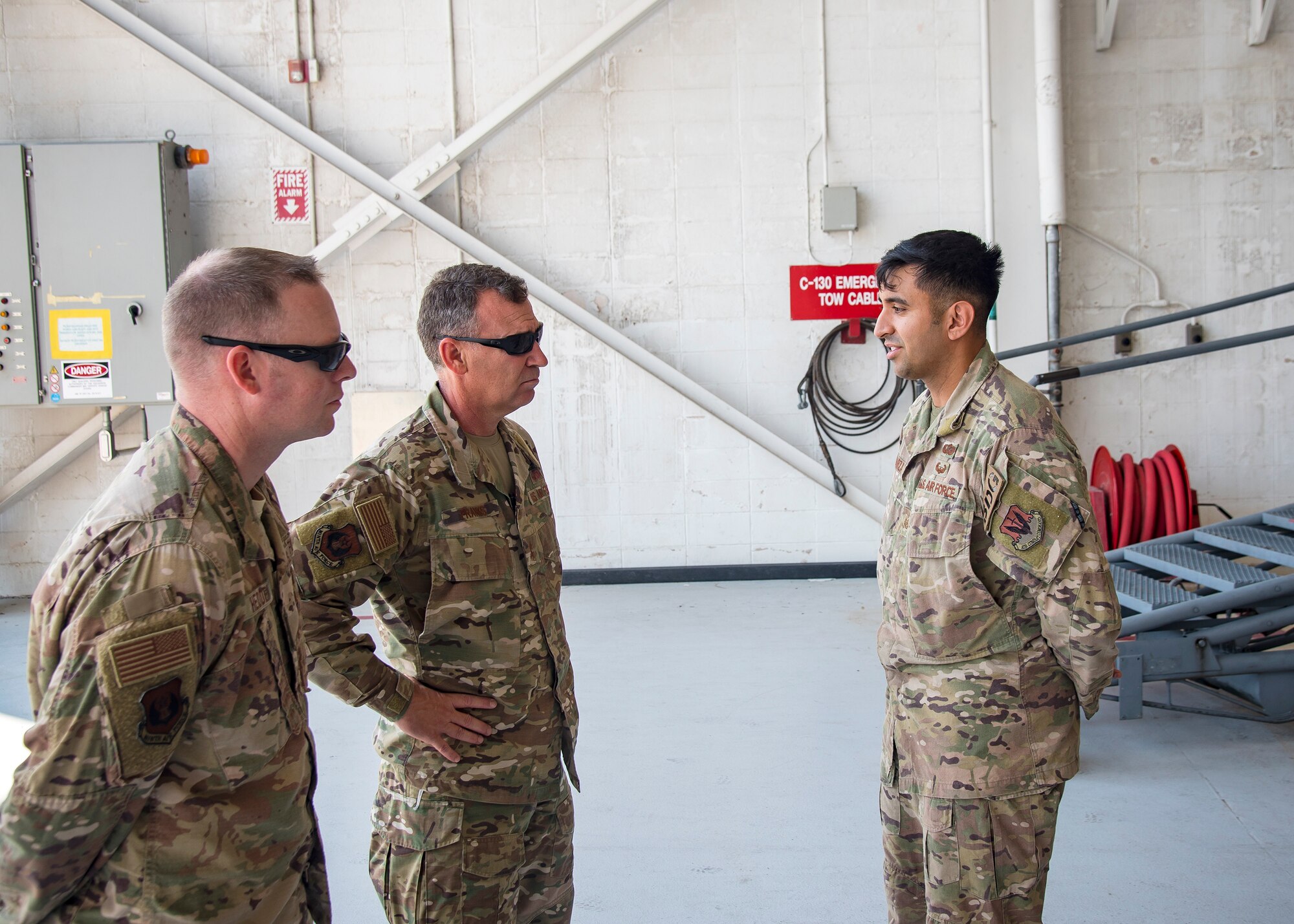 U.S. Air Force Maj. General Chad Franks, center, Ninth Air Force commander and Chief Master Sgt. Benjamin Hedden, Ninth AF Command Chief, speak with an Airman from 820th Base Defense Group, Aug. 9, 2019, at Moody Air Force Base, Ga. Franks, who on separate occasions served as the commander for the 23d Wing and 347th Rescue Group, is a command pilot with more than 3,300 hours in multiple aircraft including HC-130J Combat King II and HH-60G Pave Hawk. (U.S. Air Force photo by Airman 1st Class Eugene Oliver)